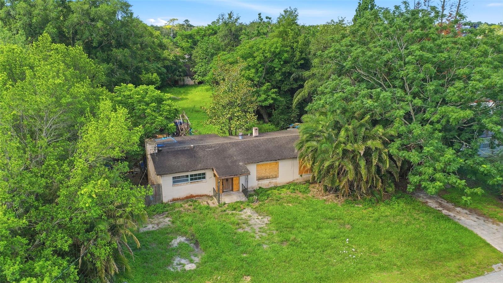 UNLIMITED POTENTIAL & NO HOA ON A MASSIVE LOT! 0.69 acres! This property is the ultimate blank canvas for investors, builders, or anyone looking to build equity from the ground up. With a sprawling lot and absolutely no HOA restrictions, the possibilities here are endless. The existing structures are a true blank canvas, ready for a complete top-to-bottom renovation. Whether you want to take it down to the studs and build your custom dream home or start entirely fresh, the value here is in the land and the location. Bring your boat, RV, or commercial vehicles, build a detached workshop/guest house, or design a custom backyard oasis. Incredible location just minutes from UCF, Lockheed Martin, and Downtown Orlando. Bring your contractor and your vision to unlock the massive upside of this rare find!