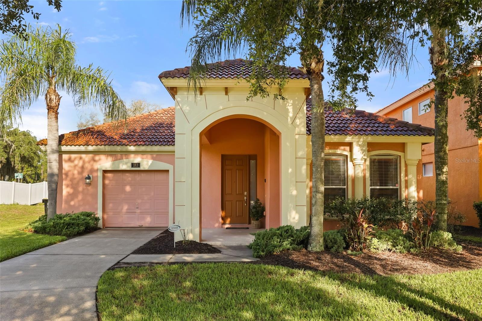 Turnkey Furnished. Rental Ready. Earning From Day One. 183 Tiger Lily Court is the rare vacation property that asks nothing of its next owner but a signature. Fully furnished down to the linens, this four bedroom, three bath home sits inside the guarded gates of Watersong Resort, minutes from Walt Disney World, in a community where short term rentals are permitted and guests already know to look. A private pool and heated spa open onto a conservation lot with no rear neighbors, just water and open sky, the kind of view that sells a booking before a guest even checks in. The kitchen anchors an open living and dining layout built for groups, with a center island, breakfast bar, and enough cabinetry to handle turnover after turnover. The primary suite holds the ground floor with direct pool access, a dual sink vanity, and a walk in shower, while three additional bedrooms, including one finished in a Disney theme, are built to fill every bed on every trip. A Jack and Jill bath serves two of the rooms, and the converted garage now runs as a games room with a pool table and basketball game, the kind of extra that turns a one time guest into a repeat one. Watersong Resort backs it all with a 24 hour guarded gate, clubhouse, resort style community pool, fitness center, and playground, amenities that do half the marketing for you before a single photo goes up. Listed at $349,999, this is a property that steps in and starts working immediately. Buyer's agent required for all showings. Schedule your private showing today.