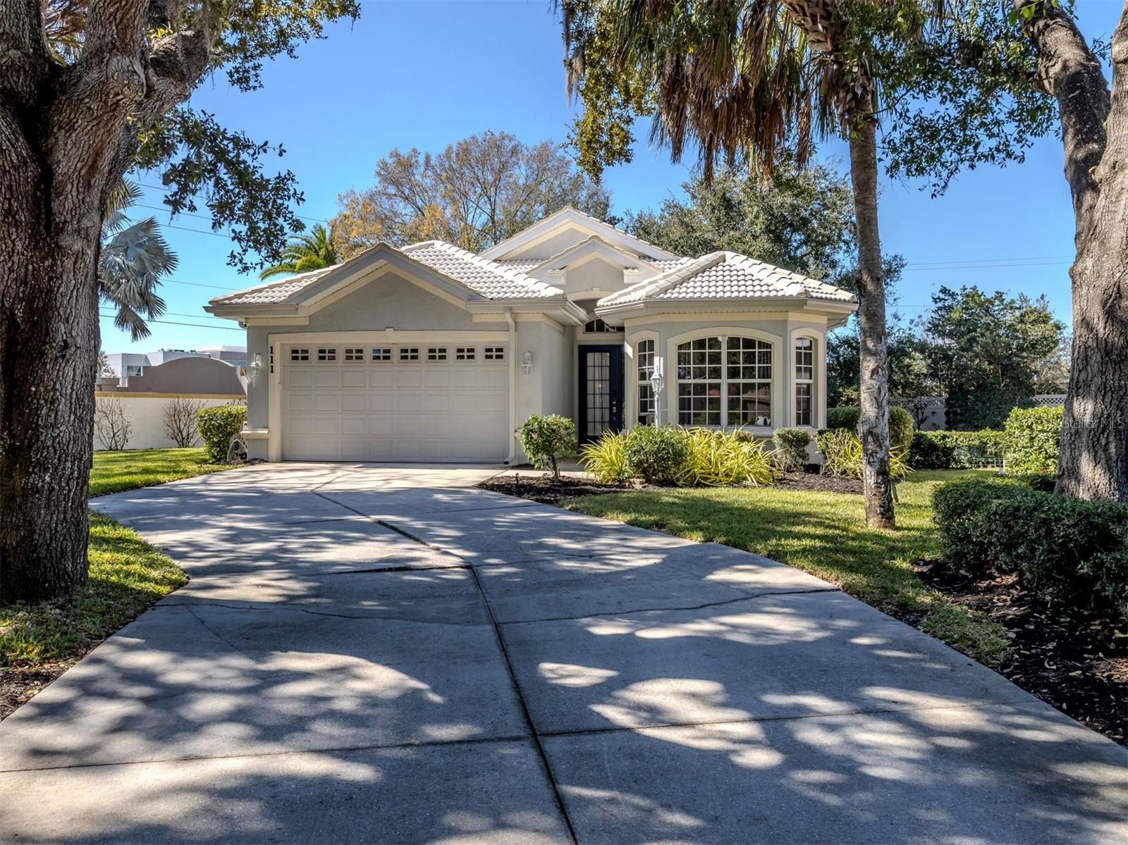 Desirable, turnkey furnished, this light-filled David Hunihan custom-built three-bedroom, two-bath residence offers refined Florida living in the gated, member-owned Venice Golf and Country Club. Thoughtfully updated with a new air conditioner, water heater, fresh paint, newly painted garage floor and walls, enhanced landscaping with irrigation and smart-home technology, this home is move-in ready and offered at the lowest square foot price in The VGCC. A welcoming front entry with glass transom and sidelights opens to an airy, open-concept floor plan featuring a generous dining area, living room, kitchen and breakfast nook. Tall tray ceilings, graceful arched doorways, profile corners and custom details create a warm yet contemporary ambiance throughout. A stunning, newly renovated kitchen showcasing light wood soft-close cabinetry, granite countertops, a breakfast bar, luxury appliances and abundant storage, serves as the heart of this home. An enclosed Florida room, complete with a pool table, is fully air-conditioned with its mini-split system and hurricane-impact windows, offering additional year-round living space. Tile flooring enhances the main living areas, while luxury vinyl flooring in all three bedrooms provides comfort and easy maintenance. The spacious primary suite features a tray ceiling and a well-appointed en-suite bath with walk-in shower, dual-sink vanity, large soaking tub and private water closet. The second and third bedrooms present flexibility for guests, family or a home office, and the third bedroom includes a pocket door for privacy and a large bay window. A shared second bath with a shower/tub combination serves these bedrooms. Out back, the lanai is equipped with a 240-volt electrical hookup, ready for a hot tub or swim spa, ideal for relaxing and enjoying Florida lifestyle. The Venice Golf and Country Club has been recently reimagined. The expanded clubhouse features a spacious gathering bar, gourmet and commercial kitchens and a cozy fire pit. Members enjoy casual and special event dinners throughout the year. The new state-of-the-art Wellness Center offers massage therapy, fitness classes, yoga, physical therapy and personal training that provide a holistic approach to health and well-being. Beautifully renovated Ted McAnlis-designed 18-hole championship golf course is treasured and highly rated as one of the best and well-maintained golf courses in the region. Residents also enjoy Har-Tru tennis courts, bocce ball, and a Junior Olympic-sized pool and spa, balancing active living with relaxation. As a Geo-Certified Audubon Cooperative Sanctuary, VGCC embraces environmental stewardship and sustainability. With an A+ financial rating, the community is as solid as it is serene. Ideally just minutes from airports, shopping, dining, Interstate 75, cultural venues and Wellen Park is this charming home. It's also a short drive to the treasured Venice Island, where 14 miles of pristine beaches meet the sparkling Gulf Coast. Don’t miss your chance to own a beautiful home in one of Venice’s sought-after friendly communities. Country Club living reimagined.