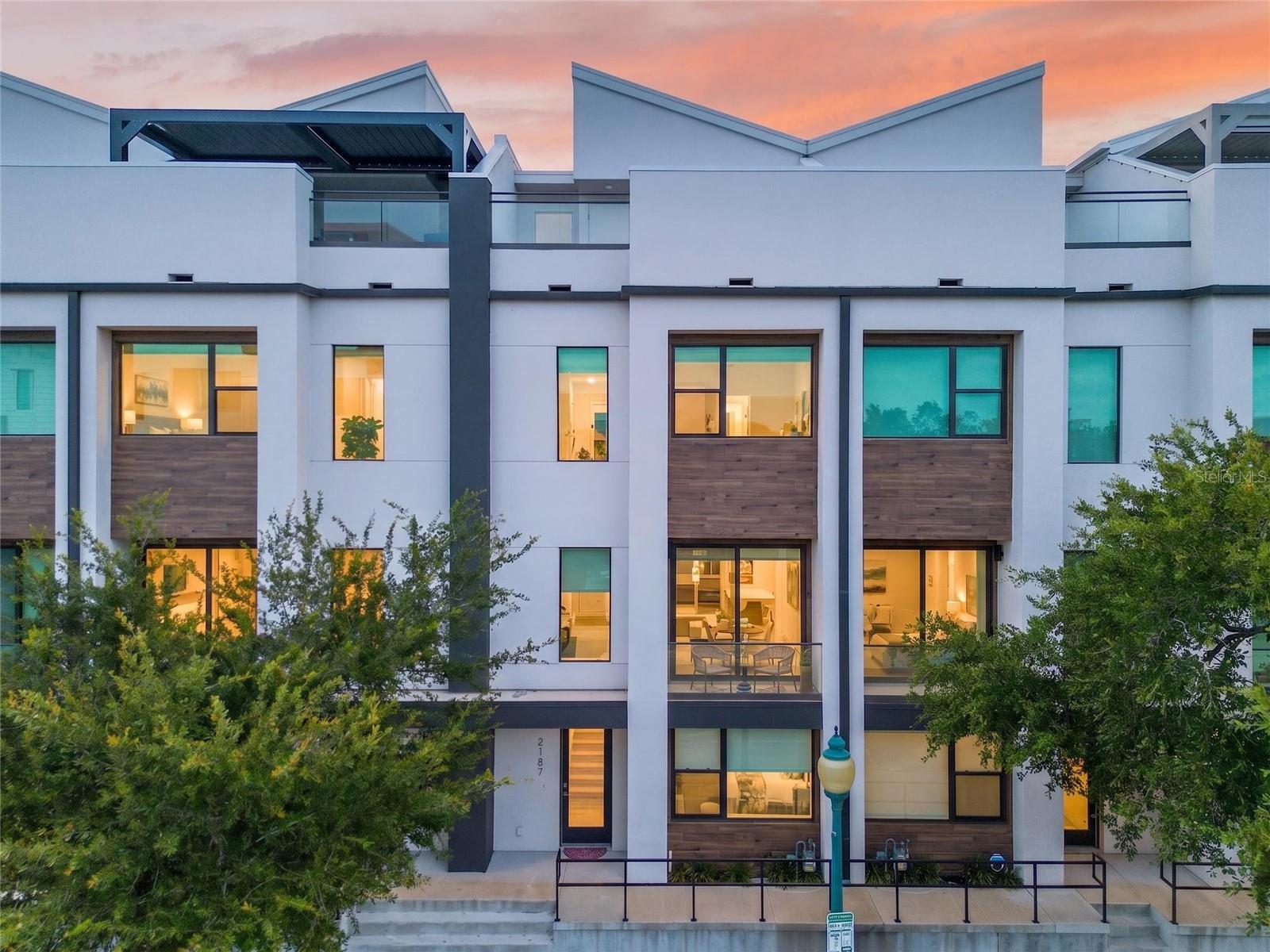 Luxury Downtown Sarasota Townhome | 2023 Construction | Private Elevator | Lockout Suite | Walk to Everything

Experience the ultimate Downtown Sarasota lifestyle in this stunning four-story luxury townhome, built in 2023 and perfectly positioned in one of the city's most prestigious and walkable neighborhoods. This is more than a home—it's an opportunity to enjoy the vibrant energy, culture, and sophistication that make downtown Sarasota one of Florida's premier luxury destinations.

Imagine leaving your front door and strolling to award-winning restaurants, upscale boutiques, rooftop lounges, art galleries, coffee shops, weekend farmers markets, live theater, the Sarasota Opera, Marina Jack, Bayfront Park, and breathtaking sunsets along Sarasota Bay. Spend your mornings walking the waterfront, afternoons shopping on Main Street or Palm Avenue, and evenings enjoying world-class dining and entertainment—all without getting in your car. Just minutes away are the pristine white sands of Lido Key, St. Armands Circle, Longboat Key, and some of the Gulf Coast's most celebrated beaches.

Inside, every detail reflects contemporary luxury. Offering approximately 2,350 square feet across four thoughtfully designed levels, this residence showcases elegant porcelain flooring, dramatic floating wood staircases with sleek glass railings, soaring ceilings, and premium finishes throughout. A private elevator services every floor, providing effortless convenience and accessibility.

The gourmet kitchen is designed to impress both everyday cooks and entertainers alike, featuring Frigidaire Gallery appliances, an Electrolux vented hood, gas cooktop, convection double ovens, soft-close cabinetry, abundant storage, and an open-concept design that seamlessly connects the living and dining spaces.

A standout feature rarely found downtown is the first-floor private lockout suite with a full bath, offering exceptional flexibility for guests, multigenerational living, a luxury home office, fitness studio, or potential income-producing opportunities.

Step outside and entertain in style with your private outdoor kitchen complete with gas plumbing and sink—perfect for enjoying Florida's year-round sunshine. Additional features include a spacious two-car attached garage, energy-efficient 2023 construction, and a low-maintenance lifestyle that allows you to spend more time enjoying everything Sarasota has to offer.

Whether you're searching for an exceptional primary residence, an elegant seasonal retreat, or a high-demand investment property, this home delivers luxury, flexibility, and an unbeatable location in the heart of one of Florida's most sought-after downtown communities.

Homes of this caliber in Downtown Sarasota are rarely available. Schedule your private showing today and discover why luxury buyers continue to choose downtown Sarasota as the Gulf Coast's premier destination for upscale urban living.