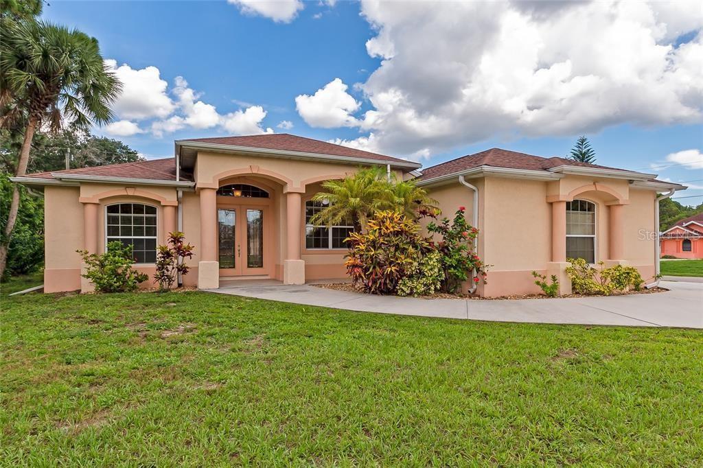 One or more photo(s) has been virtually staged. Showings are available daily by appointment only. Interior is currently painted in a light gray hue. City water. Oversized parcel that sits high above street level. Circular, extra-long double driveway offering ample parking. Large, sun-filled garage with the option for a window A/C unit. A new roof is in progress. This house has never flooded. Zero hurricain damage. Due to the positioning of the parcel, the home benefits from excellent natural ventilation, allowing a pleasant cross-breeze to flow throughout when doors and windows are open.

The interior features soaring ceilings, a French-door vestibule, oversized windows in every room, and a versatile central flex space. The functional kitchen flows through to the laundry area and into a bright breakfast nook with lanai access. The primary bath includes a walk-in shower and a private enclosed water closet with its own window. Outside, enjoy a shaded lanai with TV setup and a lovely breeze, overlooking an oversized lot perfect for gardening, BBQs, or a future pool. 

Centrally located  - Highly accessible, walkable, rollable, Pedestrian-friendly with paved, level access. " Functional Convenience Score" is 8/10 . Near numerous shopping destinations at Cocoplum Village Shops, including Publix Super Market, ALDI, and TJ Maxx, as well as AdventHealth Medical Group Multispecialty. School bus stops close by.