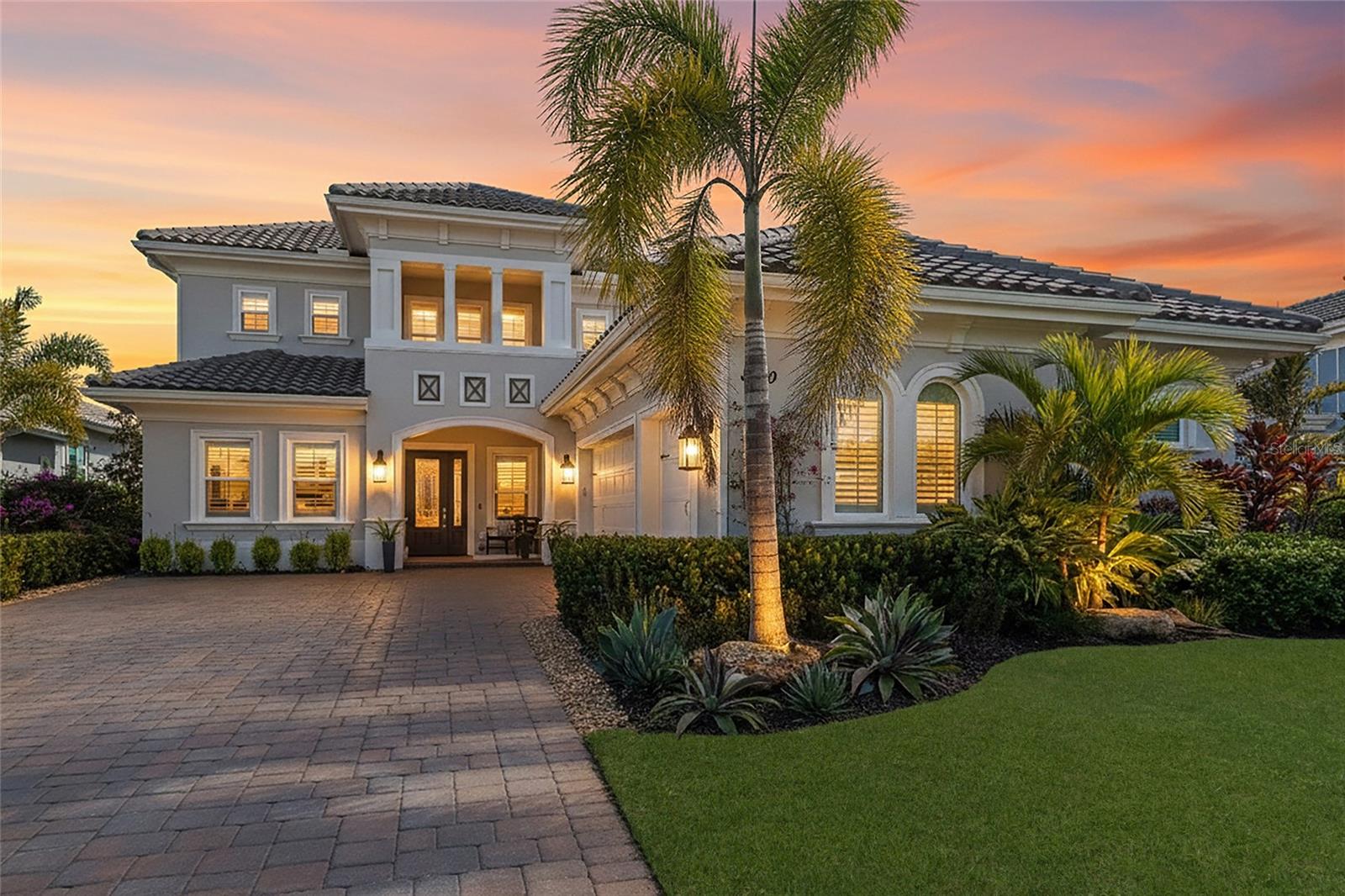 Behind the gates of The Lake Club, this beautifully designed five-bedroom, four-and-a-half-bath residence with a private office, and an upstairs bonus room offers the space, quality, and lifestyle today’s buyers expect. Built for both comfort and peace of mind, the home features hurricane impact glass, a whole-house Generac generator, and integrated smart home capabilities. Inside, refined finishes include plantation shutters, tray ceilings with crown molding, quartz countertops, and an open-concept layout centered around a well-appointed kitchen with gas cooktop, built-in ovens, and large island. An additional flex room provides versatility for formal dining, a second office, music room, or whatever best suits your needs. The living areas flow seamlessly to a panoramic-screened lanai showcasing a gas-heated saltwater pool and spa with sun shelf, along with a fully equipped outdoor kitchen—ideal for year-round entertaining. The primary suite offers private lanai access, customized walk-in closets, and a spacious bath with soaking tub, walk-in shower, and dual vanities. Designed with abundant storage throughout, including generous closets and a spacious laundry room with utility sink and built-in cabinetry, the home also features an oversized three-car garage and a thoughtfully designed second-level retreat with bonus room, guest suite, and full bath—completing this exceptional offering in one of Lakewood Ranch’s premier communities.Lakewood Ranch is the number one best-selling, multigenerational community in the country and located near world-class shopping, dining, entertainment of Lakewood Main Street, University Town Center, downtown Sarasota and is minutes to I-75, beaches, great schools and medical facilities. Membership to the Lakewood Ranch Golf and Country Club is optional.