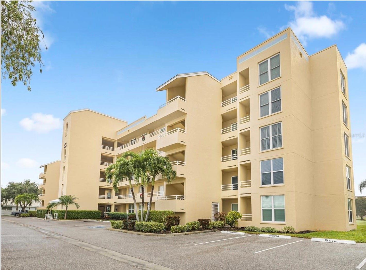 Welcome to this Pinebrook Condominium end unit offering additional windows and natural daylight where you'll find the comfort and livability you'd expect from a home with this generous 1406 sf floor-plan of living area. Enjoy the convenience of having a third room that is currently set up as a Study/Bonus Room along with 2 Bedrooms and two Bathrooms. An expansive 17' x 12' kitchen offers abundant coveted counter and cabinet storage space along with a pantry closet and charming Breakfast Nook area where you can savor your meals while taking in views of the outdoors.  This home is inviting and comfortable!  It has been tastefully decorated with quality finishes including plantation shutters, crown molding, an electric fireplace, a 2023 A/C, hardwood floors, berber carpeting in the bedrooms, tile on the diagonal in the lanai, ceiling fans, updated bathrooms that feature modern mirrors and fixtures, an attractive custom built-in wall unit in the Study/Bonus Room, a new washer and dryer and 3 built-in large cabinets in the Laundry Room for added extra storage that make it a standout feature of that space. Enjoy the security and energy savings of hurricane rated impact windows in nearly every room, only the primary bedroom and sliding glass doors are non-impact. Wind down as evening sets in and soak in the views of the golf course and pond from your lanai. Enjoy resort style living with pay as you play golf along with additional amenities that includes tennis courts, pickleball, a fitness workout room, bbq facility, a Golf Pro Shop, Clubhouse, pool, fitness and recreation center. Your monthly fee of $636 covers water, sewer, trash, basic cable, internet and pest control. You'll have your own assigned covered carport right across from the elevator in addition to a designated storage unit. This is a pet and age friendly building. You'll love the convenience of the nearby Sarasota/Bradenton airport, GT Bray Park, Tampa, Florida State University, St. Armand's Circle and Bradenton's beautiful beaches less than 7 miles away!