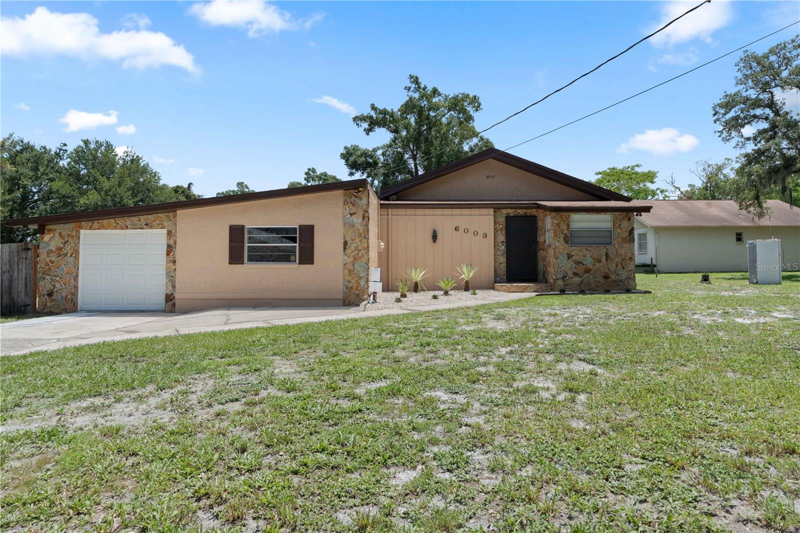 DOUBLE LOT!  You can separate and divide and build on the 2nd Lot or keep for storage. Welcome to 6003 N Fremont Ave.  This 3 bedroom home PLUS an office, 2 bathroom home has been refreshed with all new tile, Carpet, light fixtures and more. Walk into a spacious Family room  that is light and bright.   The bedrooms have a 3 way split with 1 bedroom to the left of the entrance.  A 2nd off the family room and the primary with a wall of closets and an ensuite bathroom.  There is an extended 1 car garage.  Located close to Grocery shopping, restaurants.parks, schools and quick access to I 275.