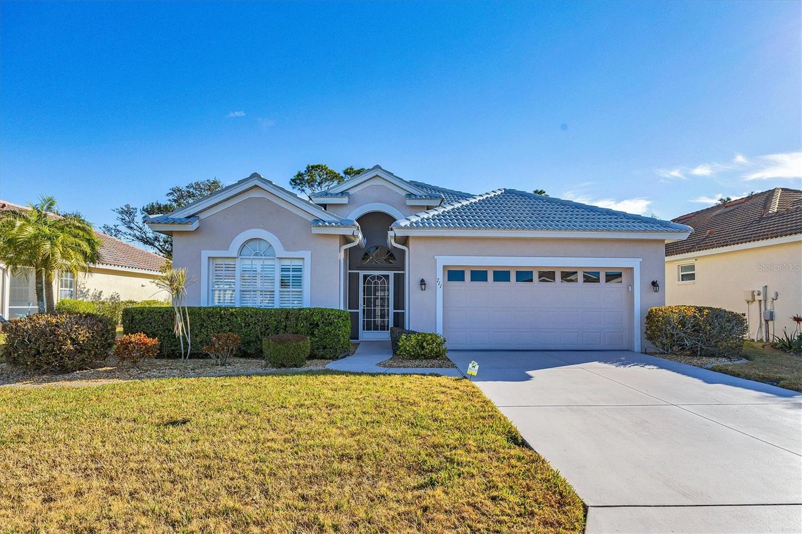 DON'T WAIT! SEE THIS PROPERTY BEFORE IT IS GONE!!  Popular Palmetto floor plan offers 2BD/2BA/Den/2CG.  Open Floor Plan with High Ceilings gives the impression of a much larger home. Infused with natural light  through out the day.   Kitchen updated with GRANITE counter tops, STAINLESS STEEL APPLIANCES (brand new refrigerator) and WATER SOFTENER at sink.  Your breakfast nook is permeated with morning sunshine through the bay window.  Inviting living area with built in shelving for your entertainment enjoyment.  Open the sliding doors to the very spacious lanai-650 sq ft of open space fully screened is perfect for entertaining with its outdoor kitchen and wood burning fireplace.  Throw a party or spend a cozy evening at home in paradise. Very PRIVATE lanai is surrounded by tropical landscaping.  Eastern exposure ensures that it is never too hot for happy hour!! Back inside, the Expansive dining room with tray ceiling and crown molding exudes elegance and has a dry bar just steps away. Put it all togrther and you have an magnificent space for entertaining.  Luxurious master bedroom with en suite bath that has 2 separate sinks/vanities, walk in shower, and garden tub for soaking your cares away.  Very spacious walk in closet.  Enhanced by tray ceiling, crown molding and PLANTATION SHUTTERS  on windows. Guest bedroom at other end of home for privacy, guest bath shared by bedrooms  Immense SEPARATE DEN has a closet and FRENCH DOORS so it can be used as a THIRD BEDROOM, NOW being used as an office. Both bedrooms have PLANTATION SHUTTERS that enhance the windows. Laundry room with wash sink.  If the party is over and you want to enjoy the AC,  no problem AC was put in Sept 2023 with a 10 year parts and labor warranty. .  Original roof had a comprehensive inspection in 2023 and was granted with an additional 20 years left on it. For extra protection, it was updated with "Permakote" weatherproofing system that includes a 15 year transferable warranty.  IF INTERESTED,  please remember that hitting the contact agent button on most third party websites will no get you to the listing person.  Search lower in the fine print if interested in contacting this person. Pelican Pointe is Venice's premier community with resort style amenities- Clubhouse with restaurant/bar/grill, heated pool, fitness center, tennis courts, pickle ball, tons of social activities, social room/library, 27 holes of golf and pro shop. Huge and very active Women’s Association with tons of activities to choose from. Golf membership is NOT mandatory. LOW HOA fees. All centrally located minutes to Venice Beach, Venice Downtown, shopping, theatres, restaurants, highways, airports, and so much more. Come find your Florida Lifestyle today!