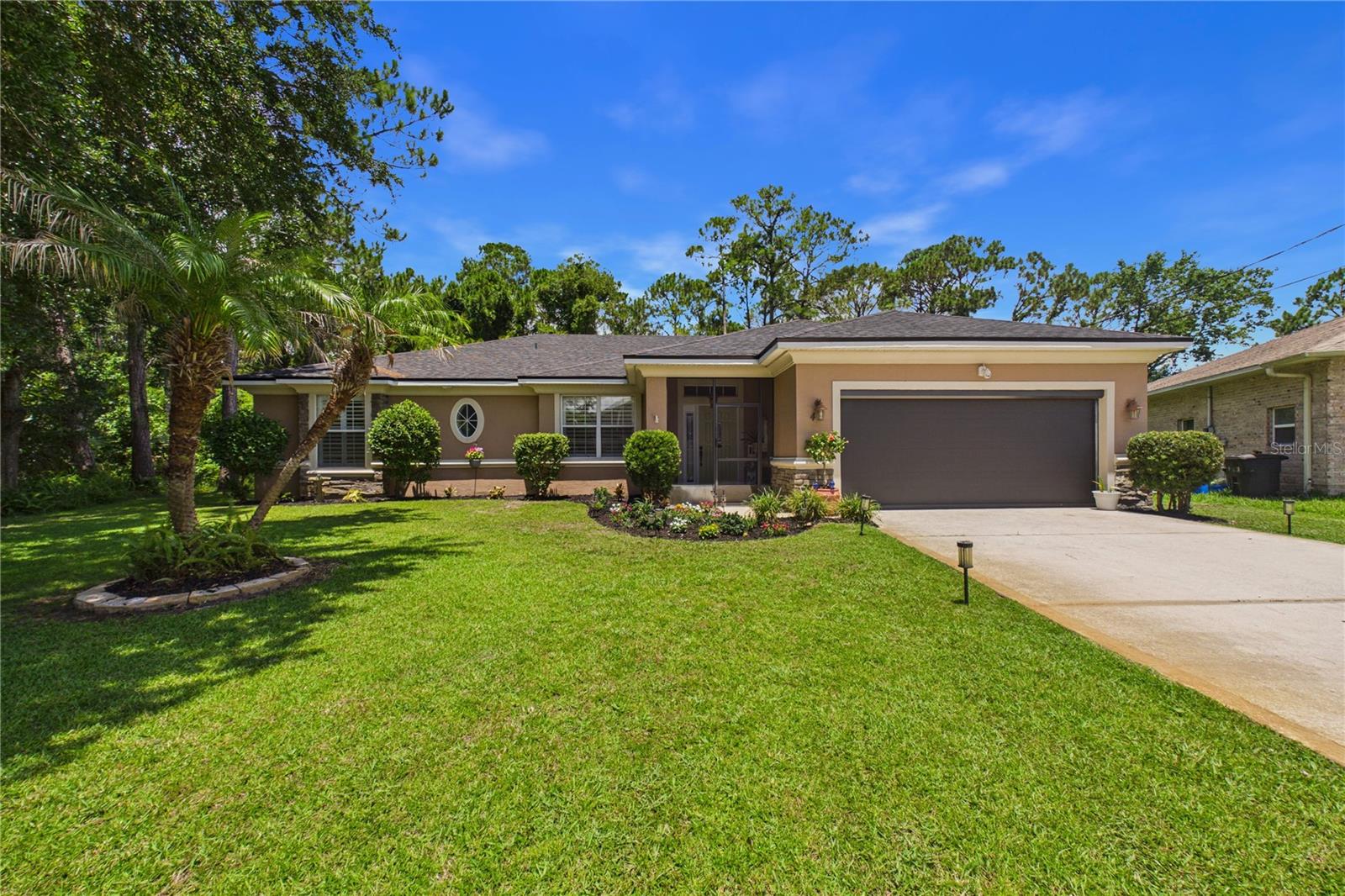 Y ! Beautiful 3/2/2 with numerous upgrades such as; newer roof installed in 2025. Beautiful tile flooring throughout . Plantatian shutters on all windows . The kitchen has Newer granite, cabinets and appliances. Nicely finished laundry room complete with shelving, and a folding area & rack for hanging clothing. Lighted mirror in the living room is an additional nice touch. Primary Bedroom has remote-controlled lighting with dimmers conveniently located over the bed. Overhead storage in the remote-controlled screened garage door . A Roku doorbell camera and security cameras with integrated speakers. Additionally, there are Foscam cameras installed in the office and living room. The backyard is extremely impressive! Flowering trees.Fruit trees; Olive, fig tree, 2 banana trees ,2 Plantain trees, Grapefruit and, 2 Hybrid Orange / tangerine trees. Raspberries grow wild on the outer perimeter of the fence. There is a pathway leading to pond access just enter through the gate
