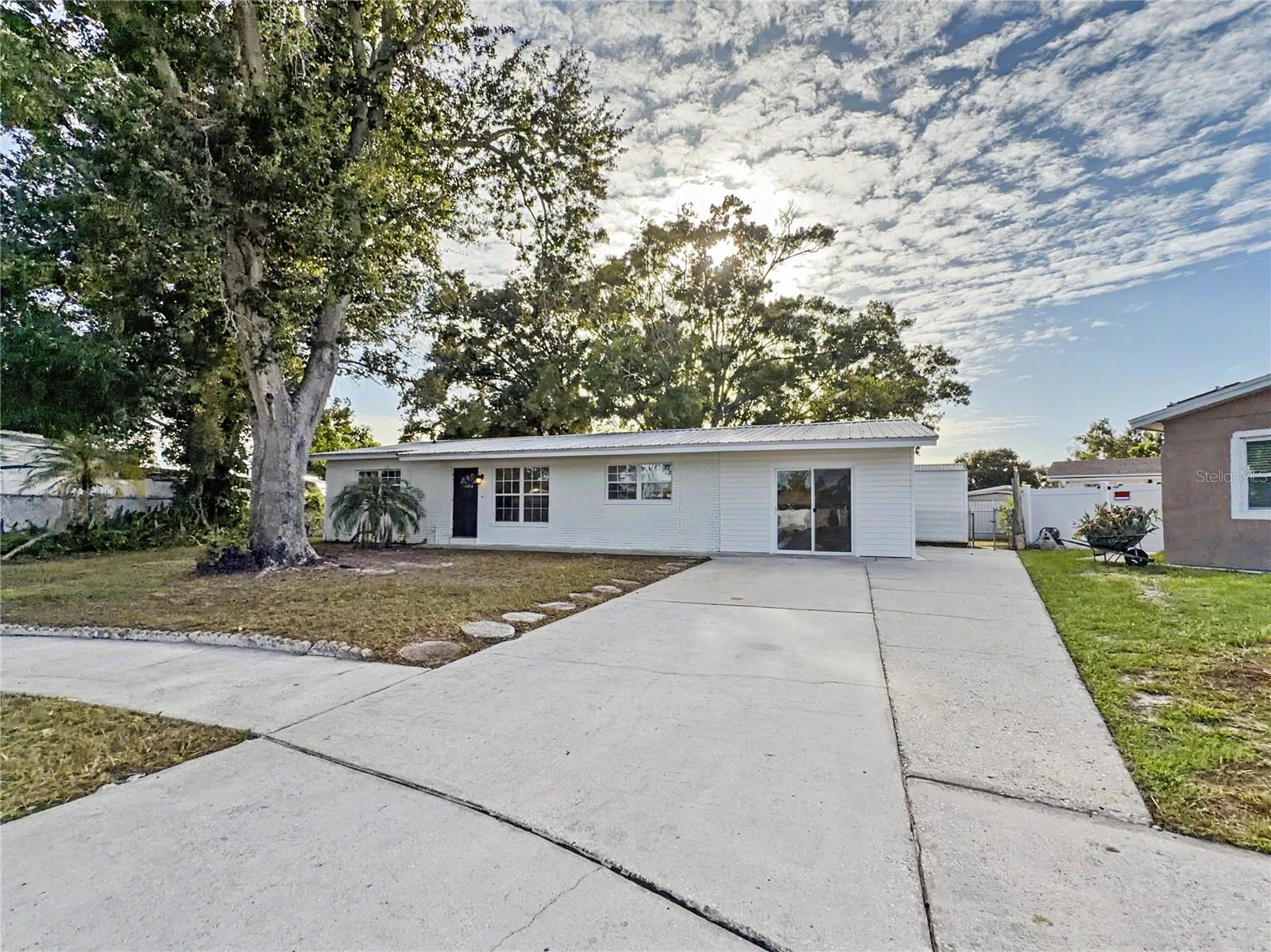 Beautifully updated block 3 bed, 2 bath home with a large Bonus Room.  This house sits on a large quarter-acre lot right at the end of a cul-de-sac.  Major 4 point items handled, which include the ROOF (2018), HVAC (2023), Water heater (2021), Electrical panel (2021).  Recently updated Hurricane rated windows, professionally painted Interior and exterior and new Washer and Dryer (2025).  Bright open living area with wood flooring, a large bonus room, and a sun filled Florida room, flexible space for an office, gym, or playroom or 4th bedroom. Kitchen offers abundant cabinetry, breakfast bar pass through, and eat in dining. Newer metal storage shed, spacious yard with room for a boat or trailer, no HOA, no CDD. Minutes to Tampa International Airport, the Veterans Expressway, and the Gulf beaches. Professional interior photos coming. Schedule your showing today.