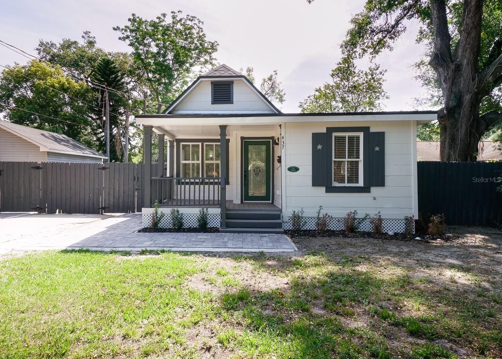 Step into timeless charm and modern comfort with this beautifully renovated 3-bedroom, 2-bathroom 1915 bungalow, perfectly situated on a picturesque brick street in the heart of downtown Orlando. This move-in ready historic home blends classic character with contemporary updates throughout. A welcoming driveway and covered front porch lead you into an inviting great room with luxury vinyl plank flooring that flows seamlessly through the home. French doors open to a showstopping kitchen featuring striking blue cabinetry with gold hardware, stainless steel appliances, quartz countertops, a stylish tile backsplash, and a dining area overlooking a private paver patio—perfect for relaxing or entertaining under the stars. The spacious primary suite boasts a walk-in closet and a beautifully updated en-suite bath with a quartz vanity and subway tile tub/shower. The second bedroom also features a walk-in closet, while the third offers a reach-in closet—both sharing a modern, well-appointed hall bath. All bedrooms include ceiling fans and 2” cordless wood blinds for added style and comfort. Additional features include a dedicated laundry area with a high-capacity washer and dryer, new roof, new windows, upgraded insulation, new A/C ducts, updated plumbing and electrical systems, and energy-efficient LED lighting throughout. Enjoy the convenience of a prime location—just steps from the YMCA, walking distance to Lake Eola and Thornton Park, and close to top hospitals, major roadways, and a wide variety of dining and shopping options.