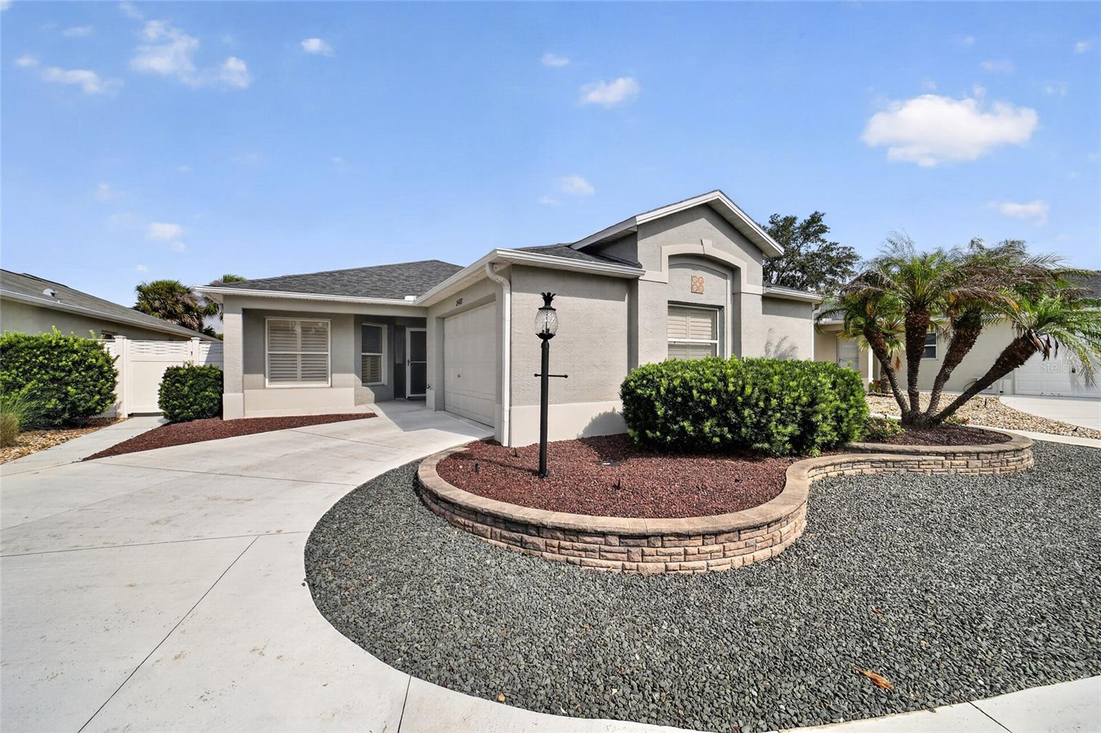 What a BEAUTIFUL home with NO BOND! 3/2 Courtyard Villa is move-in ready with neutral tones and luxury vinyl plank flooring throughout. Tastefully furnished and offered TURNKEY this home provides an updated kitchen and baths, a 2024 ROOF, 2018 HVAC....there's nothing to change here! High ceilings in all rooms along with plantation shutters give you a light and bright feel. Kitchen features granite counters, cabinetry with pull outs, newer white appliances and breakfast bar. Spacious dining area and living room calls for friends to come on over! The roomy primary suite boasts a custom walk-in closet, granite vanity, walk-in tile shower, and linen closet. The two additional bedrooms include custom closets, a shared bath with granite vanity and tile tub/shower combo. The exterior is low maintenance at its best! You'll enjoy peaceful living from the screened lanai with sounds of the palms in the breeze. The expanded sidewalk and patio area lends well for outdoor living, even room for a pool! Inside laundry room with cabinetry and utility sink plus a 1.5 car garage round out all the positives of this home. Can't beat the LOCATION with Lake Sumter Landing and Brownwood both nearby, 466A is super close for shopping and restaurants. The Hadley Pool, Odell Rec Center and Havanna CC & restaurant will become your go to spots...if you aren't golfing nearby!