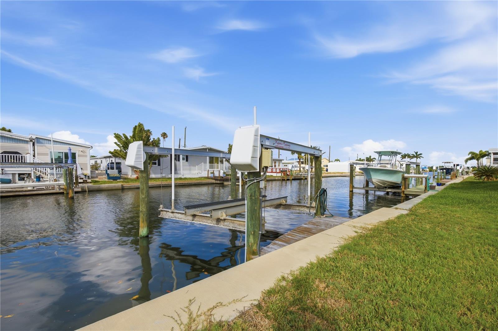 Under contract-accepting backup offers. If you've been dreaming of an affordable waterfront boating lifestyle, this is your chance. This rare 50-foot canal-front homesite in the sought-after 55+ waterfront community of Tropic Isles includes a private boat dock and an approximately 4.5-year-old 10,000-pound boat lift, providing quick, direct access to Terra Ceia Bay and beyond. Whether you enjoy fishing, cruising, or spending the day on the water, this location puts it all at your doorstep.
The property includes ownership of the Certificate of Title Share—a $75,000 value—and offers the perfect opportunity to install a brand-new manufactured home designed to your taste. The existing trailer is uninhabitable and will need to be removed. With an acceptable offer, the seller will have it removed prior to closing, giving you a clean slate to create your ideal Florida retreat. For added value, the association maintains the seawall and sea cap.
Tropic Isles is a resident-owned, 60-acre waterfront co-op community known for its active lifestyle, friendly atmosphere, and remarkably low HOA fees. Residents enjoy a heated pool and spa, marina, community boat ramp, bait shop, clubhouse, fitness center, library, and a full calendar of social activities. Located just minutes from Snead Island, the Bradenton Yacht Club, Emerson Point, waterfront restaurants, and some of the area's best fishing and boating destinations, this is waterfront living at its best. Pet-friendly and lease-friendly, Tropic Isles offers an exceptional opportunity to enjoy the Florida lifestyle without the high cost of traditional waterfront ownership.