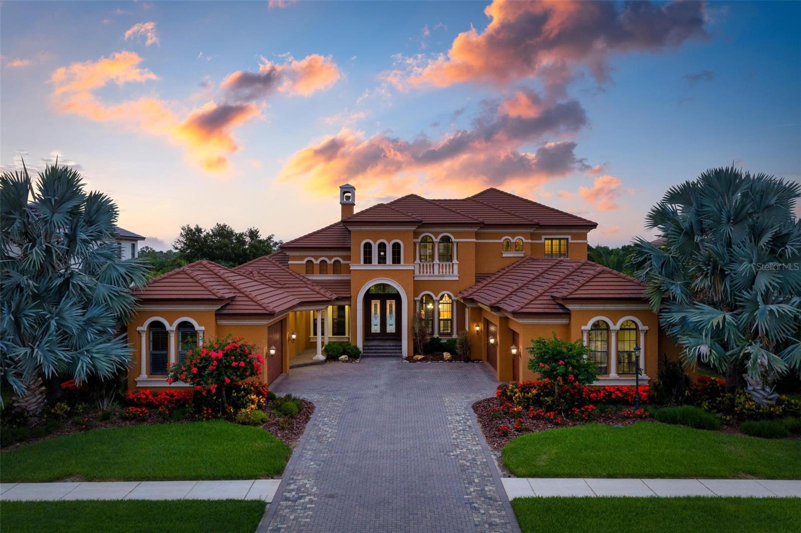 Virtually Staged. Custom Two-Story Riverfront Estate Situated on a 1.26-acre cul-de-sac lot with 103 feet of direct frontage on the Manatee River, this custom estate features 5,668 square feet of interior living space and an extensive list of structural and cosmetic upgrades. The exterior boasts a new roof installed in 2021, a 5-car garage, and a whole-house backup generator added in 2022. Waterfront amenities include a private, covered boat dock equipped with an electric boat lift, giving direct water access right from the backyard.
The fully remodeled gourmet kitchen features quartz countertops, premium solid wood cabinetry, and commercial-grade appliances including a built-in Sub-Zero refrigerator/freezer and a Viking range/oven system. The interior offers a central vacuum system, a wood-paneled elevator, fireplaces in nearly every room, and two tankless hot water heaters for seamless energy efficiency.
The primary level includes a completely reimagined primary bathroom. The traditional tub has been removed to make way for a slate stone walk-in shower that looks out toward a custom, illuminated stone waterfall feature. Additional living spaces include a grand stairway, a dedicated home theater room, and a second-level bonus room with a wet bar and pocket sliders opening to a wraparound balcony.
The outdoor entertainment oasis features a covered lanai, a summer kitchen, and an uncovered infinity-edge pool with an integrated spa. The entire pool area is accented by custom LED ambient lighting, which connects to a separate paved patio area featuring a built-in gas fire pit overlooking the river. Residents of Winding River also enjoy community access to a private boat ramp and nature preserve.