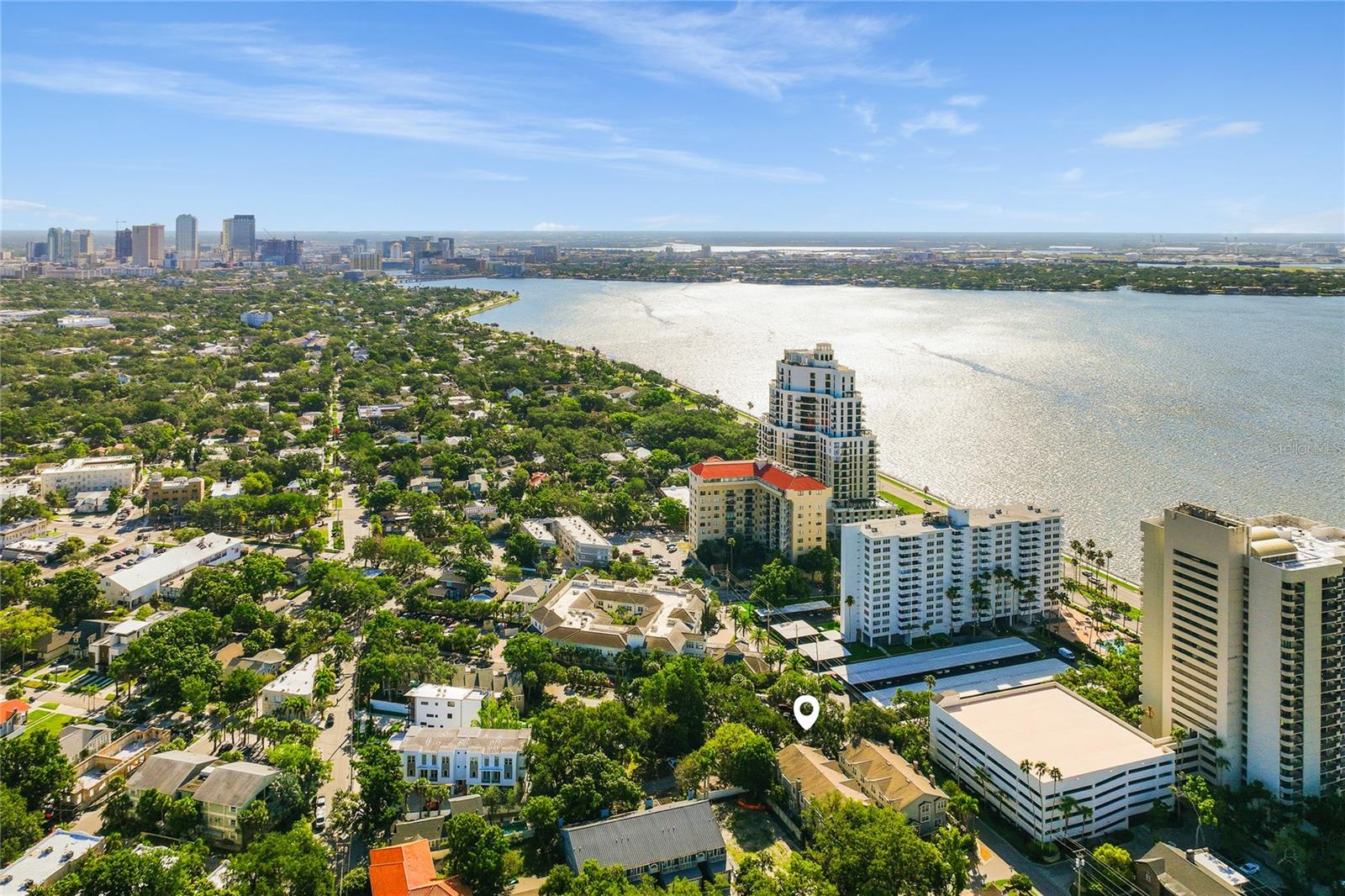 Welcome to one of South Tampa's most elegant and meticulously renovated townhomes, perfectly positioned just moments from the world-famous Bayshore Boulevard. This stunning three-bedroom, two-and-a-half-bath residence spans three thoughtfully designed wood floors, offering the ideal blend of sophisticated style, functional living and the coveted South Tampa lifestyle. From the moment you enter, soaring thirteen-foot ceilings, rich crown molding, and a beautifully appointed wood-burning fireplace with a custom new mantle set the tone for the refined finishes found throughout. The open-concept kitchen and dining area overlook the main living space below, creating a seamless, airy flow perfect for entertaining or relaxed everyday living. A private outdoor retreat extends your living space into Florida's beautiful sunshine. Every inch of this home has been thoughtfully updated within the last five years, including a stunning modern kitchen designed to be the dynamic social hub of this home. Ascend to the third floor where complete privacy awaits. All three bedrooms are tucked away from the main living areas, creating a true sanctuary. The showstopping master suite features soaring vaulted ceilings, a spacious walk-in closet with custom built-ins and a spa-inspired primary bath that rivals the finest resorts—complete with dual sinks, a luxurious soaking tub, frameless shower, and indulgent heated floors. The two-car garage adds everyday convenience, a rare and valuable feature in this sought-after South Tampa corridor. Located steps from Bayshore Boulevard—one of the longest continuous waterfront sidewalks in the world—residents enjoy morning runs, sunset strolls, waterfront festivals, world-class dining, boutique shopping at Hyde Park Village and the vibrant energy that defines South Tampa living. This remarkable offering represents extraordinary value and an unmissable opportunity in the Bayshore living walkable enclave. Move in ready. Private. Perfectly located. This is South Tampa living at its finest.