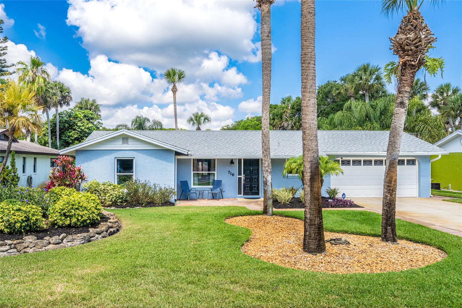 VERY RARE HOME WITH DETACHED INLAW SUITE IN CENTRAL BEACH! You do not want to miss this opportunity! Large 75x140 lot that is landscaped impeccably with mature palm trees! Flanked by the shaded roof covered outdoor bar this home is ready to add a pool if you desire. Main home is a remodeled and redesigned 2 bedroom 2 bathroom. The primary bedroom with ensuite has been redesigned not typical to the floor plan of many similar homes in the area being that it has been expanded including a large walk-in shower with closets added. The main living area is very open to the remodeled kitchen including 36" upper cabinets, soft close drawers, mini fridge, instant boiling water dispenser, and granite counter tops all surrounded by a 9 ft island very conducive to entertaining! 24 x 10.5 patio off the back of the home has windows and is cooled by the window AC unit making this room enjoyable throughout the year. Oversized 2 car garage great for storing your vehicles and golf carts which are used as the preferred way of getting to the grocery store, many fine restaurants, shops, entertainment on nearby Flagler Ave or to the beach a couple blocks away! Massive 32' x 14.5' additional storage is located off of the in-law suite perfect for beach toys and hobbies. The additional 1 bedroom 1 bathroom in-law suite is approx. 534 sq. ft including an updated kitchen, living area, walk-in closet, and bathroom that has an enclosed outdoor shower. Other wonderful features of this home include hurricane windows, R-39 insulation in the attic, new duct work, and 5 1/4" baseboards to name a few. ;Water: City