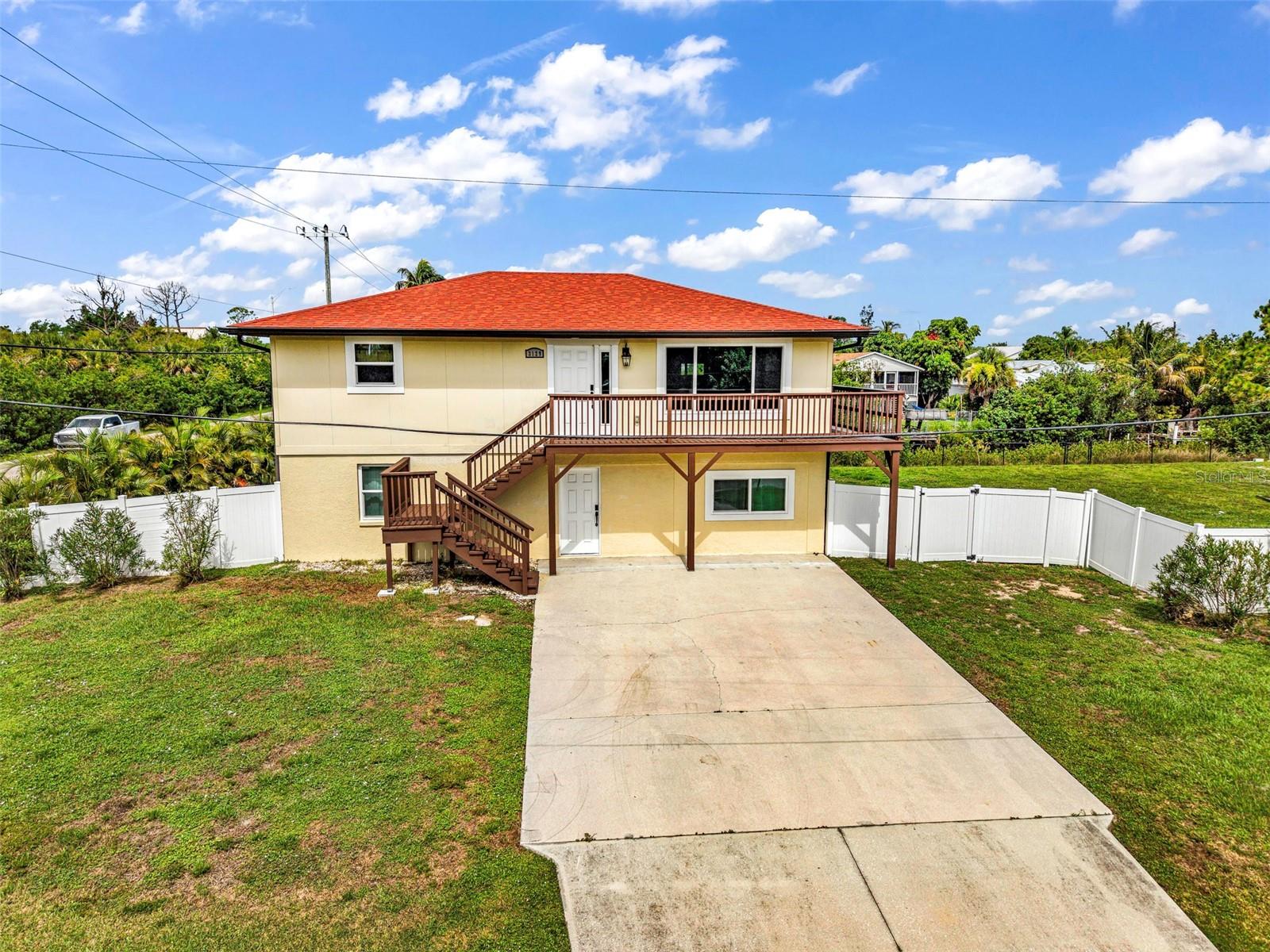 Experience the best of Southwest Florida waterfront living with this incredible opportunity in the highly desirable Charlotte Park community! Situated on TWO fully fenced lots with an impressive 147 feet of canal frontage, this versatile two-story home offers direct boating access to Charlotte Harbor, making it the perfect fit for boaters, investors, or anyone looking for flexible living options. Beautifully renovated from top to bottom, this move-in ready home leaves nothing untouched. Featuring a NEW roof, NEW impact-rated windows and doors, TWO beautifully updated kitchens, NEW flooring throughout, completely renovated bathrooms, and countless additional interior and exterior improvements, every detail has been thoughtfully updated so the next owner can simply move in and start enjoying the Florida lifestyle. Designed with versatility in mind, the lower level features its own private entrance complete with a spacious bedroom, full bathroom, comfortable living area, and fully equipped kitchen—creating the perfect setup for families, extended guests, seasonal visitors, or income-producing rental potential. Upstairs, natural light fills the open living spaces where you'll find two additional bedrooms, an updated kitchen with plenty of room to gather, an inviting living area, and an expansive wraparound deck overlooking the canal—the perfect place to enjoy your morning coffee or unwind while taking in breathtaking Florida sunsets. Outside is where this property truly shines. The oversized double lot offers endless opportunities for entertaining, gardening, pets, or storing your boat, trailer, RV, and all your waterfront toys. Launch your boat right from your backyard and spend your days exploring Charlotte Harbor, waterfront restaurants, nearby islands, and the Gulf of Mexico. Whether you're searching for a full-time residence, seasonal retreat, vacation rental, or a home that comfortably accommodates the entire family, this property offers exceptional flexibility without sacrificing the waterfront lifestyle. Opportunities like this—with 147 feet of canal frontage, two fully fenced lots, direct boating access, an extensively renovated interior and exterior, and a flexible floor plan—are few and far between.