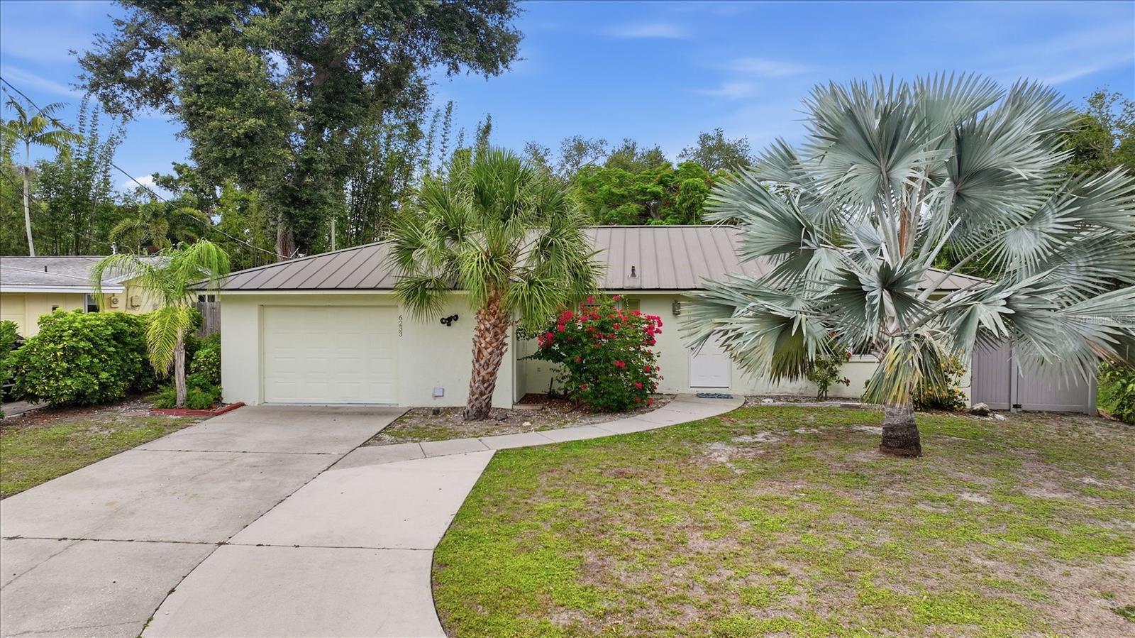 Your Private Sarasota Sanctuary Awaits! Tucked away in a quiet neighborhood, this beautifully updated 2-bedroom, 2-bathroom pool home perfectly blends serene seclusion with an unbeatable coastal lifestyle. Step inside to a sun-drenched, open-concept floor plan defined by elegant tile flooring, completely updated kitchen including solid surface countertops,  Updated cabinetry and stainless steel appliances.  Beyond the kitchen, awaits a flexible bonus sunroom that opens to the outdoors through elegant French doors. The beautifully upgraded main bathroom features a spa-like double-sink vanity. Outside, the impressive lot serves as your personal tropical oasis, boasting a sparkling screened in swimming pool, alongside a sprawling open-air brick terrace bordered by a secure privacy fence, mature palms, and soaring bamboo. Complete with a durable metal roof and spectacular curb appeal, this move-in-ready retreat sits just minutes away from the vibrant dining and shopping of Gulf Gate and the world-famous quartz sands of Siesta Key beach. Schedule your tour today!