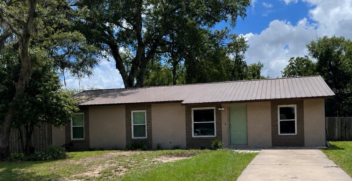 UPDATED HOME WITH BONUS ROOM, METAL ROOF & PRIME CENTRAL FLORIDA LOCATION!
 This well-maintained home offers a blend of comfort, efficiency, and convenience. Major updates include a metal roof installed in 2019, new energy-efficient windows (2019), a tankless water heater, and an upgraded higher-tonnage A/C system designed to keep the home comfortable year-round. The former garage has been professionally converted into a versatile bonus room, providing additional living space perfect for a family room, home office, playroom, gym, or guest area. Step outside to enjoy the fully fenced backyard, offering plenty of space for pets, outdoor entertaining, or simply relaxing in your own private retreat. Conveniently located with easy access to both The Villages and Ocala. You'll enjoy nearby shopping, dining, entertainment, and medical facilities.