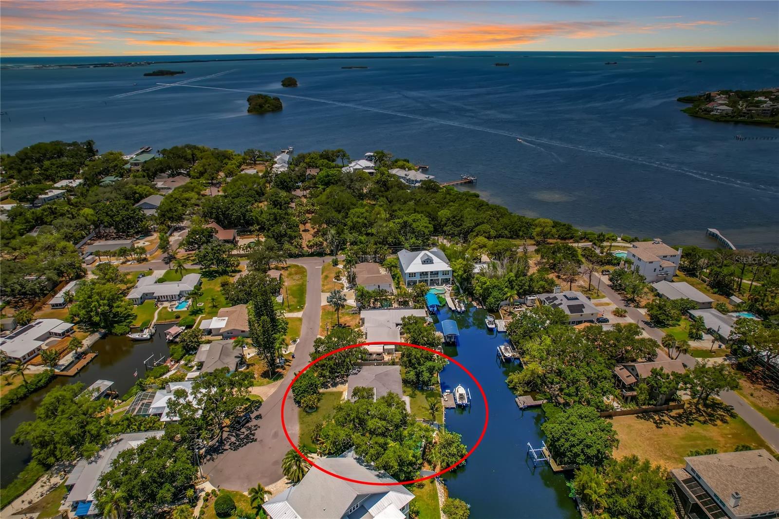 Virtually Staged. Welcome to your own slice of paradise in the charming coastal town of Ozona, Florida! This beautifully updated ranch style waterfront home offers the Florida lifestyle you've been dreaming of, complete with stunning water views, a private, composite boat dock with a 9,000 lb. boat lift and just one turn to the open Gulf! Whether you're heading out for a day on the water or relaxing by your private pool, this home is designed to make every day feel like a vacation. 

Inside, you'll love the light and bright open floor plan where the beautifully appointed kitchen features granite countertops, a matching backsplash, stainless steel appliances and overlooks the spacious dining and family room. A wall of windows line the back of the home filling the living space with natural light while showcasing the peaceful waterfront views. The thoughtfully designed triple split bedroom floor plan offers privacy for everyone, including a spacious primary suite tucked away from the guest bedrooms. 

Step outside to the screened lanai where your sparkling pool and outdoor patio create the perfect place to unwind or entertain. The fully fenced side yard offers plenty of room for outdoor games, gardening and your kiddos & pets to run and play. Additional features include hurricane impact windows, sliders and front door, a HUGE walk-in pantry/storage room off the garage, a new pool pump, fresh interior & exterior paint (2026), water heater (2025), A/C (2024), new electrical panel (2022), and the roof replaced in 2017. 

Beyond the home, you'll fall in love with everything Ozona has to offer. Walk or take your golf cart to local restaurants, waterfront taverns, live music and unique shops, while Downtown Palm Harbor is just minutes away. Enjoy Free Ice Cream at monthly Third Thursday celebrations, the annual Holiday Golf Cart Parade and countless community events throughout the year. The 47-mile Pinellas Trail, local marinas, parks, golf courses, Palm Harbor Little League and the Palm Harbor Skate Park are all nearby. Spend weekends boating to Caladesi Island, Honeymoon Island, Three Rooker Island and Anclote Key, or relax at home and enjoy spectacular waterfront sunsets. Located in the highly sought after Palm Harbor School district with Ozona Elementary, Palm Harbor Middle and Palm Harbor University High School, this is your opportunity to experience one of Tampa Bay's most desirable waterfront communities. It's time for you to start Living Your Best Florida Lifestyle NOW!!