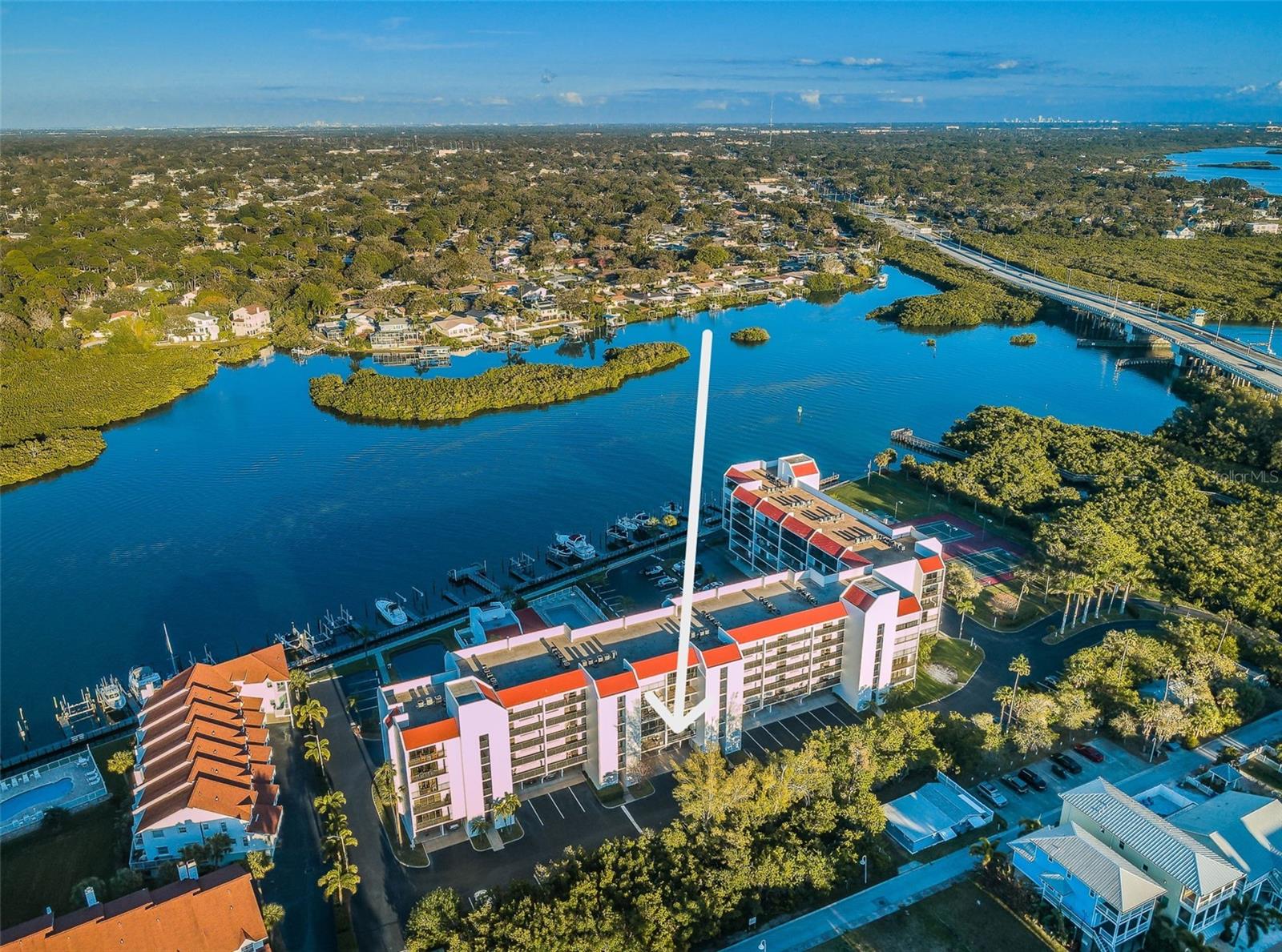 Lifestyle, Luxury & Location can be yours at Vista Bay Condos on the Intracoastal Waterway, one of Indian Shores FINEST Waterfront Condominium communities located on the “Narrows”! This SUN FILLED residence offers an UNPARELLED coastal lifestyle where breathtaking views and serene living converge.  Originally built as a boating community, you can enjoy the best of both worlds with boating, fishing & swimming on the Intracoastal side and step across the Boulevard where you can put your toes into the sugary sands of the Gulf of Mexico! This condominium situated DIRECTLY on the Intracoastal Waterway features wide open, panoramic water views and your own DEEDED BOAT SLIP (Boat Slip #1) as well as an assigned under building parking space (#25)!  Enjoy a spacious, open floor plan with 1345 SF (per Builder) and TWO (2) LARGE balconies to take in the wonderful waterfront views of the Intracoastal and pool area AND a West-facing balcony with sunset views of the Gulf of Mexico!  Boasting Two (2) GENEROUS sized bedrooms, to include a sizable WATERFRONT Primary bedroom with a California style closet, updated bath and with sweeping waterfront views to wake up daily - all providing “Suite Retreat” to the homeowner after a relaxing day.  The secondary bedroom has plenty of storage space and an updated, contemporary second bath with a spa-like ambiance.  This spacious third-floor unit features a large, bright contemporary Kitchen with quartz counters, tile backsplash, breakfast bar, separate social island, large pantry, stainless steel appliances all adjoining a wide-open living and dining room combination with stylish porcelain tile flooring, ample closet and storage space, inside utility closet with a full-sized, stack washer & dryer and a newer A/C system.  There are sliding glass doors located in the living area, primary suite and second bedroom which open to separate, large screened enclosed balconies where you can savor each sunrise and sunset over the water creating a TRANQUIL backdrop for your coastal lifestyle.  Vista Bay is a well-maintained complex with a secured lobby, is beautifully landscaped and tucked away from Gulf Blvd. and extremely well managed with plenty of reserves. The amenities are outstanding, featuring a private dock for convenient boat parking and overnight stays and this unit has a DEEDED Boat Slip - a true Boaters delight! Additionally, there are lighted tennis & pickle ball courts for active recreation, a refreshing heated, Inground swimming pool and spa, outdoor grilling facilities, shuffleboard, car washing station, 50 guest parking spots and more! Walking distance to many fine local restaurants, short drive to Seminole & the New City Center Shopping Plaza, easy access to Clearwater Beach, Tampa & the Airport, Downtown St. Pete and the Jolley Trolley, providing inexpensive transportation from St. Pete Beach to Clearwater Beach. Tranquil, Waterfront living can be yours in this wonderful community with 75 total units on 6 floors and built in 1983! Your waterfront lifestyle awaits at Vista Bay condos in Indian Shores — make the move today!