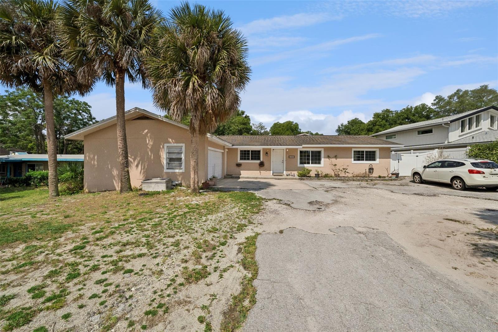 Set on .79 acres with 75 feet of frontage on a peaceful non-motorized lake, this no-HOA property offers a private backyard setting with a swimming pool, oversized covered patio, and space for multigenerational living or rental potential. The main residence features 4 bedrooms, 3 full bathrooms, and approximately 2,300 square feet of living space designed around the lake and pool views.

The remodeled kitchen opens to the dining and living areas and includes granite countertops, 42-inch cabinetry, built-in oven, and breakfast bar seating, creating a functional layout for both daily living and entertaining. Luxury vinyl flooring runs throughout the main living areas, with ceramic tile in bedrooms 3 and 4. The primary suite includes two walk-in closets, a garden bath, granite countertops, and a walk-in shower with multiple shower heads and rain shower feature. Bedroom 2 includes a private en suite bath with walk-in shower and granite countertop. Large sliding doors lead to the covered patio overlooking the pool and water.

The detached two-story Additional Dwelling Unit (ADU) has its own private entrance and offers approximately 1,216 square feet of living space. Downstairs features a living area, open bedroom space, full bath with shower, and real hardwood flooring. Upstairs includes a second living area, full kitchen, bedroom, and half bath. The flexible layout is well suited for guests, extended family, home office space, or income-producing opportunities.  Call today for your private showing!