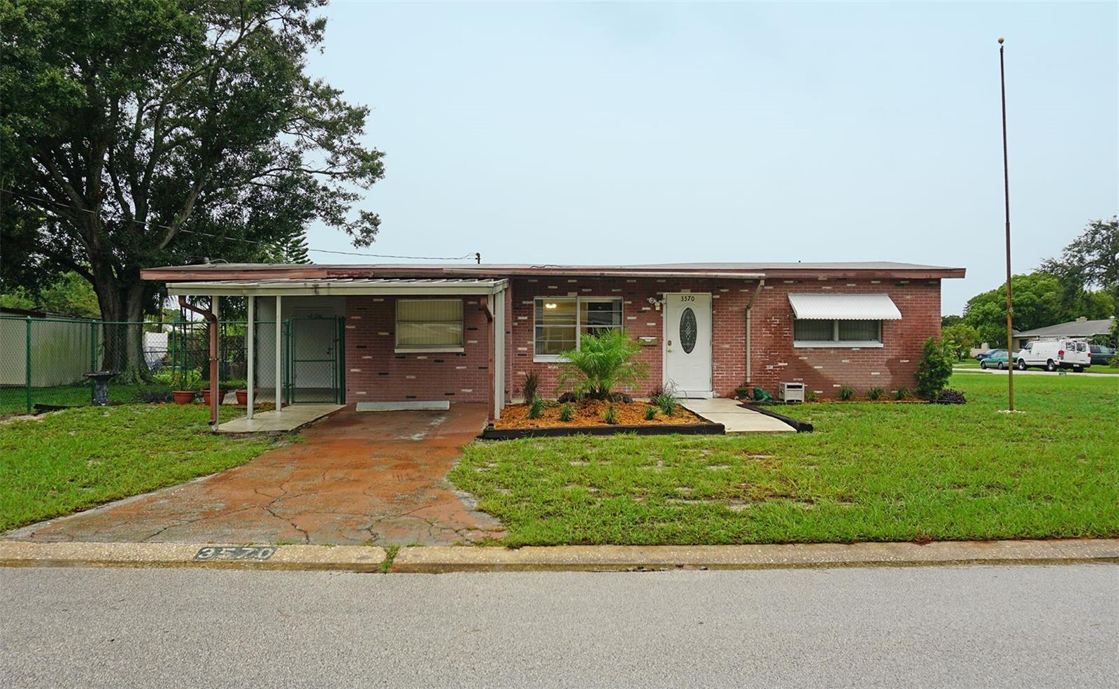 A great house on a double corner lot with plenty of parking and a large fenced in yard. Room for a boat, RV - whatever you need to park. One mile to Tyrone Mall with its surrounding restaurants, shopping and entertainment. This home features an oversized living room and separate den. Inside utility room with extra storage and washer and dryer included. Large covered lanai with attached room that could be a workshop, third bedroom (exterior entrance) or storage room. Large shed in the fenced in area of the backyard. The fence has a double gate. Covered parking on the driveway. Minutes to the beautiful Florida beaches.