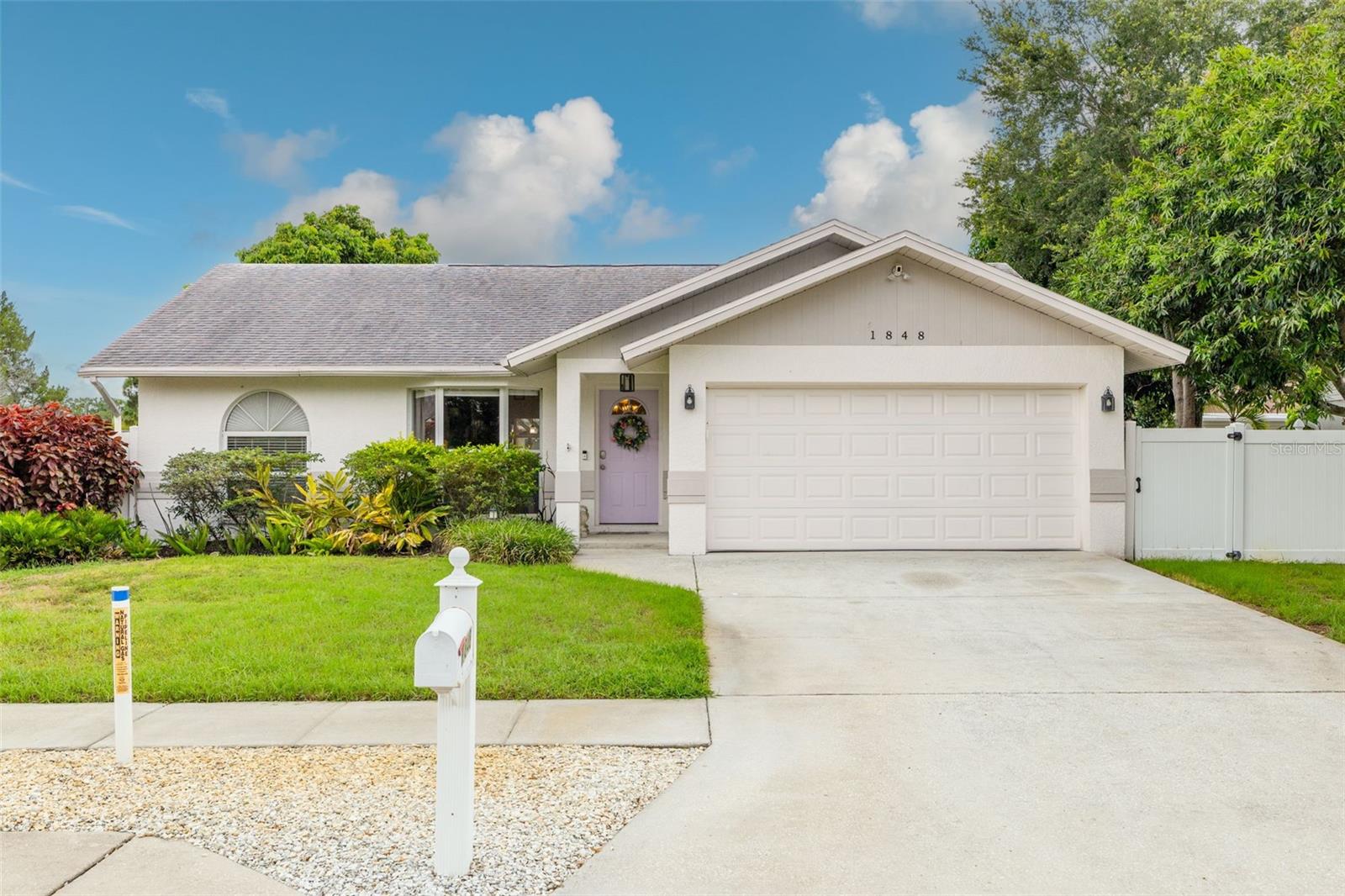 Immediate CASH FLOW and a PRIME LOCATION! This solid block-construction home, built in 1996, offers an incredible opportunity to instantly add a high-performing asset to your portfolio. The property is TENANT-OCCUPIED through January 31, 2028, generating $2,995 per month in reliable rental income.  Featuring over 1,300 square feet of living space, the home feels exceptionally spacious thanks to its soaring VAULTED CEILINGS and wide-open concept. Walk through the front door and enjoy a direct sightline through the elegant French doors to the FULLY FENCED backyard, complete with a covered back patio perfect for outdoor relaxation.  The UPDATED KITCHEN is a chef’s delight, boasting a breakfast bar peninsula, a cozy eat-in space, and abundant storage and prep area. Designed with functionality in mind, the desirable SPLIT FLOOR PLAN ensures maximum privacy. The guest wing features two generously sized bedrooms and a full bath, while the primary suite easily accommodates a king-size bedroom set and includes a walk-in closet and an ensuite bath with dual sinks and a beautifully tiled step-in shower.  Rounding out this fantastic property is a dedicated INDOOR LAUNDRY ROOM (fitting a full-size, side-by-side set) and a spacious 2-cCAR GARAGE.  Unbeatable location: Tucked away yet incredibly convenient, you are just around the corner from Target, Gandy Blvd for an easy commute, Sawgrass Lake Park, and the local YMCA. A turn-key investment with a solid build, great layout, and premium location—you truly can’t ask for more!