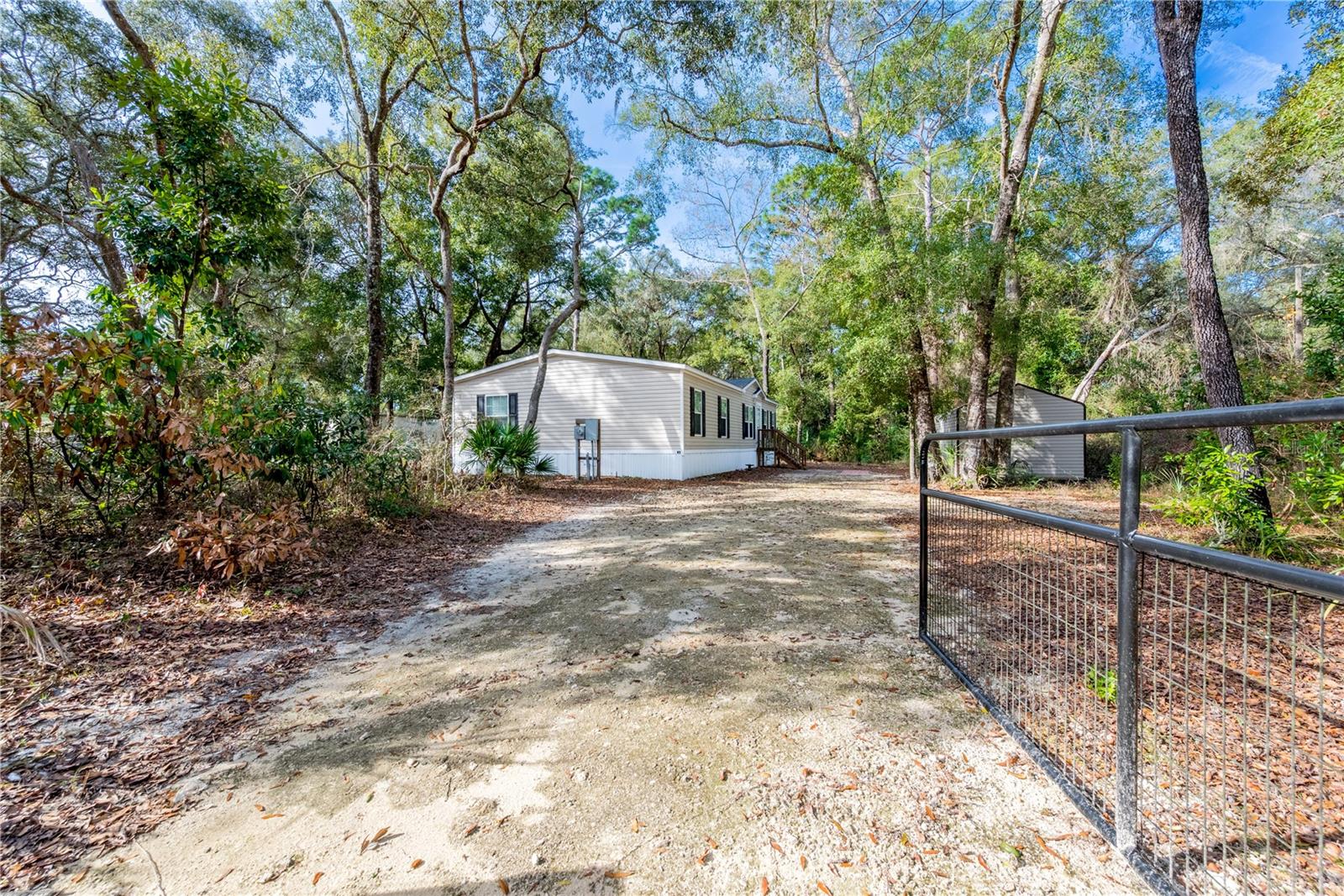 Seller is willing to consider buyer concessions toward closing costs, prepaid expenses, or rate buy-down
Practically Brand-New 2021 Home on Nearly Half an Acre – Fully Fenced & Move-In Ready

This well-maintained 2021 manufactured home offers modern comfort, thoughtful upgrades, and a peaceful rural setting just off Camp Azalea Road in Chiefland. Situated on a fully fenced 0.46-acre lot, the property provides space, privacy, and flexibility for everyday living.

Inside, you’ll find a spacious 4-bedroom, 2-bath layout with an open-concept design centered around a large granite kitchen island—perfect for cooking, gathering, and entertaining. The home has been carefully maintained and includes quality finishes throughout.

Outside, the property continues to impress with underground utilities, a water softener system, mature citrus trees, and a 12x20 storage shed for tools, hobbies, or extra storage needs. The fenced yard offers plenty of usable space for pets, gardening, or outdoor enjoyment.

Located just minutes from Manatee Springs State Park, the Suwannee River boat ramps at Camp Azalea and Clay Landing, and the Chiefland Golf & Country Club, this home offers convenient access to some of the area’s best outdoor recreation while still being close to town amenities.

Highlights:

2021 built home – move-in ready condition
4 bedrooms / 2 bathrooms
Open floor plan with granite kitchen island
Fully fenced 0.46-acre lot
Underground utilities & water softener system
12x20 storage shed included
Minutes to springs, river access, golf, and town

A great option for anyone seeking modern living