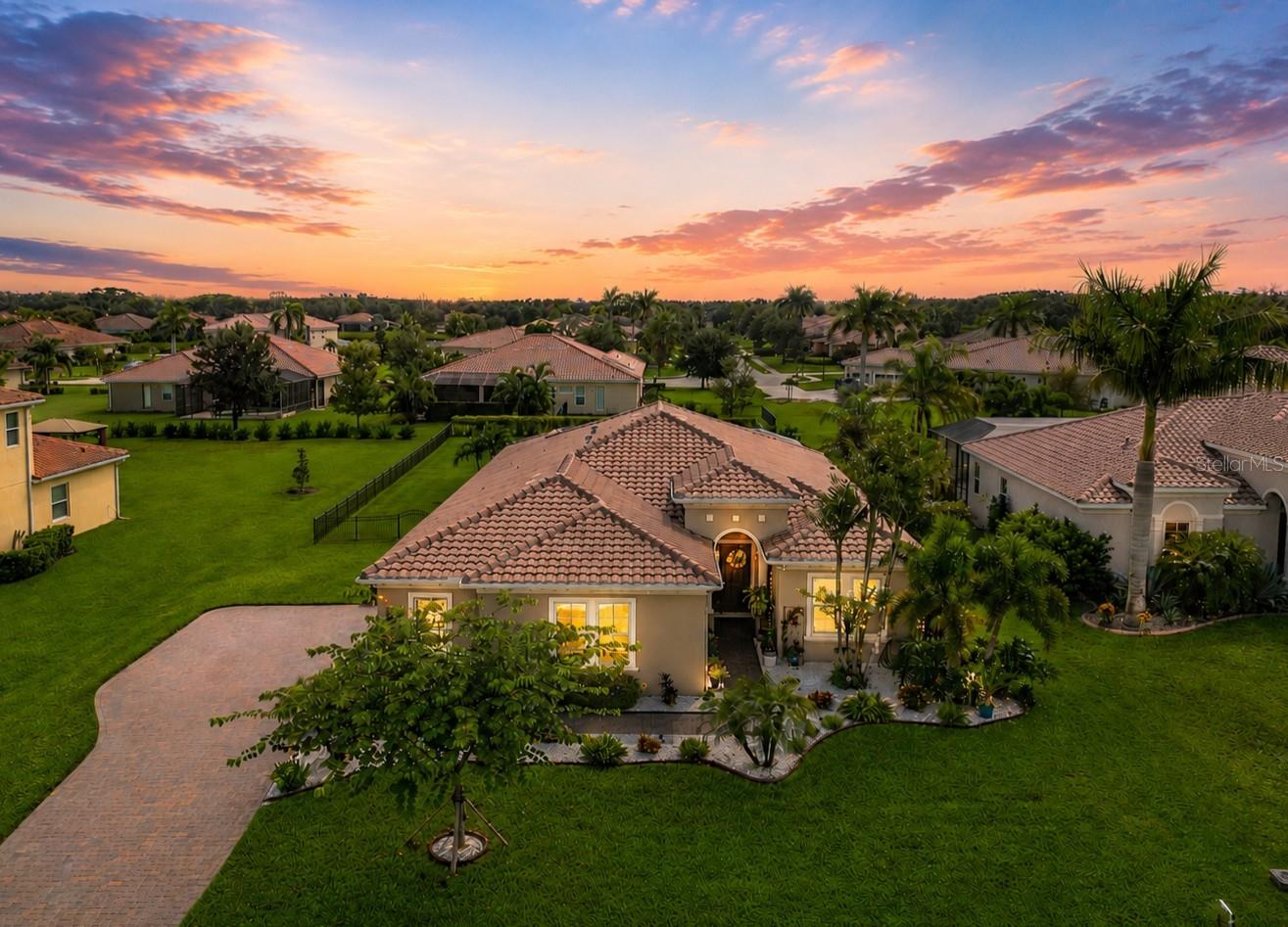 1/2 acre fenced lot, 3+ Car Garage 900 Sq ft, Salt, heated pool, Tile Roof, Paver extended driveway & 45 ft paver lanai, Luxury Vinyl & Tile flooring, Interior newly professionally painted, No CDD taxes & low HOAs. Situated on a private ½-ACRE lot, this beautifully maintained Hawthorne Model offers 2,530 sq. ft. of open-concept living with 3 bedrooms (including 2 en-suites) and 3 full baths, all with granite finishes. This popular model sits at a 50' ELEVATION & boasts a beautiful, HEATED SALTWATER POOL, tile roof, paver driveway, 45 FT EXTENDED LANAI, and a fully FENCED backyard—perfect for pets and outdoor living. Step inside and enjoy the coastal-inspired design featuring LUXURY VINYL FLOORING & TILE (no carpet), a spacious great room, and an inviting flow ideal for families or entertaining.  Calling all GARAGE LOVERS - this space is the ultimate! The oversized, side-load 3-car garage spans approximately 900 SQ FT (31’ x 29’) with space for a boat, large vehicles, gym equipment, storage & all of your toys. Roof racks included. The gourmet kitchen features gray cabinetry, a large granite island, stainless steel appliances, walk-in pantry, and plenty of room for a full-size dining table. Recent upgrades include a new dishwasher and microwave 2024. Interior - Great rm, kitchen, bath, foyer, BD #3 and home office just professionally painted for a fresh, bright look. 
Step outside to the expansive 45’ paver lanai featuring a CUSTOM DESIGNED HEATED SALTWATER POOL W/ SUN SHELF & BUBBLERS — an entertainer’s dream and a serene retreat surrounded by updated landscaping.
Additional updates *** All Carpeting removed, and Luxury Vinyl Flooring added, Epoxy Garage Flooring, Fenced Backyard, New Lanai Screening, Gutters, Additional Insulation added to attic for energy efficiency, Tall Toilets, 8 Ft Doors, Custom Wood Closet design in all bedrooms, freshly cleaned roof, and sealed driveway/lanai. The home is also wired for a generator.
The sought after Rye Wilderness is close to that makes Florida living great such as A-rated schools, nearby shopping and dining, quick access to Lakewood Ranch, and is just a short drive to world-famous Gulf beaches