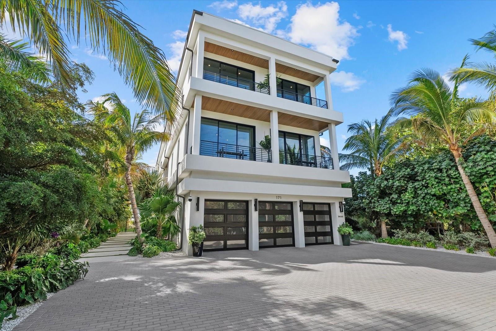 Situated among a limited collection of true beachfront estates on Lido Key, this 2023-built Gulf-front residence represents a rare opportunity to own direct beachfront property in one of Sarasota's most coveted coastal locations. Unlike the majority of Gulf-front homes that are separated from the shoreline by Gulf Boulevard and public beach parking, this property sits directly on the sand with private beach access from the residence itself. A rare natural buffer preserves both privacy and serenity, allowing you to enjoy unobstructed Gulf views without the intrusion of beachgoers. Set on .42 acres and just a short stroll from the boutiques and restaurants of St. Armands Circle, this estate offers the ideal balance of seclusion and walkability. Spanning over 6,300 square feet under air, the home features five bedrooms, six full baths, and one half bath, thoughtfully designed to capture panoramic views of the Gulf of Mexico from nearly every level. This residence is packed with modern, state-of-the-art features and architectural design elements, blending cutting-edge technology with refined coastal elegance. From the moment you enter, the horizon commands attention through expansive floor-to-ceiling pocketing glass doors engineered for seamless indoor-outdoor living. The open-concept main level showcases a Gulf-front great room and dining area, a chef's kitchen appointed with Sub-Zero and Wolf appliances, walk-in pantry, full conversation bar, and temperature-controlled wine room, all flowing effortlessly to the Gulf-front lanai with outdoor kitchen. Comprehensive smart home integration includes Control4 automation, 34 in-ceiling speakers, motorized Lutron shades throughout, and a commercial-grade elevator servicing all levels. All windows and sliding glass doors are hurricane-impact rated, providing both security and peace of mind. Every bedroom is designed as a private suite with its own bathroom and walk-in closet, offering exceptional comfort and privacy for family and guests alike. The upper level also includes a dedicated fitness studio, creating a fully self-contained retreat experience within the home. On the ground level, the Gulf-front resort-style pool and expansive entertaining terrace create a private coastal compound atmosphere. The oversized pool with negative-edge spa is complemented by multiple outdoor living and dining areas, a fully equipped outdoor kitchen, and a built-in television designed for seamless alfresco entertaining. Professionally designed landscaping and low-maintenance turf enhance both privacy and ease of ownership. A six-car garage and expansive paver driveway provide generous space for owners and guests. Offered fully furnished with select exclusions, this turnkey Gulf-front estate delivers rare direct beachfront positioning, privacy, walkability, advanced modern construction, and resort-level amenities in one of Lido Key's most exclusive settings. Contact me today to arrange a private viewing and make the dream of owning one of Lido's finest beachfront properties a reality.