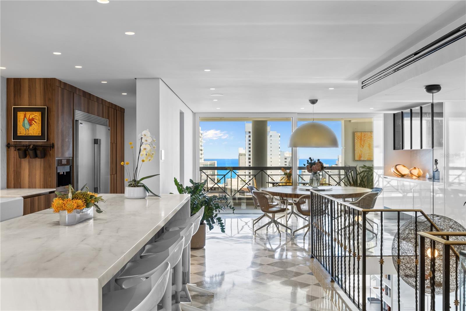 Welcome to the Penthouse at the Crowne Plaza! Located in coveted Luchetti Street in Condado, this exceptional property offers a harmonious blend of luxury, comfort, and modern design. Spanning two full floors – with an impressive 5,685 square feet, comprised of 4,697 interior sq/ft and 988 exterior sq/ft – this residence was thoughtfully designed by Pili & Co to cater to the most discerning tastes. 
Upon entering, you are greeted by expansive open spaces that seamlessly integrate with modern finishes, creating an inviting atmosphere. Lower level is the private one, featuring four bedrooms (truly convertible to five), 4 full bathrooms, a gym, a home office, a family room, and a balcony with city and ocean views. Main level is upstairs and is the social floor. There, you find an open kitchen, dining and living rooms, covered and uncovered terraces, an outdoor kitchen, a wine cellar, a fully equipped bar, pet area, and a wraparound balcony.  Both levels are connected via a grand staircase and the elevators.
The kitchen is open and bright. It features Italian CopatLife cabinets, a center-piece island with impressive Avalon marble countertops, and top of the line appliances: Miele induction stove – with a real vented range hood –, built-in Miele coffee system, Frigidaire Professional microwave/oven combo and an additional convection oven, dishwasher, and side-by-side refrigerator and freezer. The Bar also has Avalon marble countertops and is equipped with a True refrigerator, an ice maker, and a temperature-controlled 378-bottle wine cellar. 
The finishes are all custom: from Turkish marble to Swedish wooden floors, marble bathroom mosaics, custom marble sinks, and custom built-ins and doors. The windows are also hurricane-proof with integrated shutter system. The outdoor kitchen is a highlight of its own: Vision Grills bbq system, Thor range stove, Sunterra Argentinian grill, and an Italian Fontana Forni pizza oven. An entertainer’s dream for al-fresco dining!
This penthouse is distinguished by its unique two-floor layout, providing a sense of grandeur and exclusivity. The wraparound terrace is unique and offers breathtaking 360-degree city skyline vistas, making it an ideal setting for both relaxation and entertainment. The rooftop pool adds an element of luxury, allowing you to unwind while taking in the panoramic vistas. For those who value fitness and wellness, the home gym is equipped to meet your exercise needs. 
The amenities are in your own space: the salt-water pool, the outdoor kitchen, the wraparound balcony, the home office, and the gym. The terrace is a garden retreat, from bamboo to palm trees, is all about the views and the privacy. Additional features include 4 parking spaces, full power generator, and water cistern, all in a pet-friendly building with only 11 residences. The Penthouse renovation was completed in 2022 and is ready to move in.
In a prime location in Luchetti Street, the Penthouse offers convenient access to local amenities, the best schools, the beaches, fine dining, and the international airport. The neighborhood is known for its dynamic atmosphere and is a desirable location for those seeking both tranquility and urban excitement.
Experience the perfect blend of style, comfort, and convenience at this magnificent Penthouse. Contact us today to schedule a private showing and take the first step toward making this extraordinary residence your own.