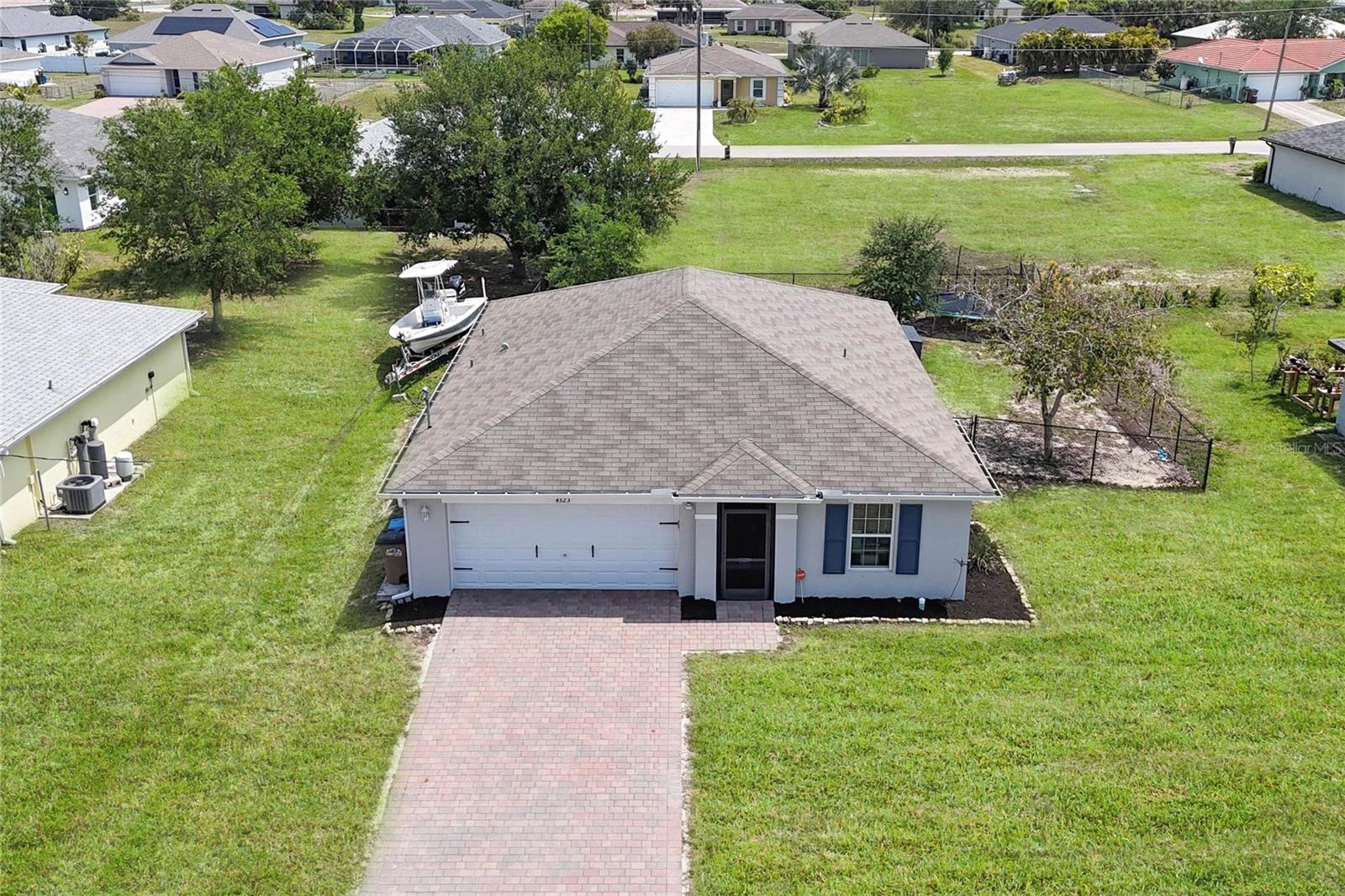 Welcome to 4323 NE 21st Ave., a well maintained newer construction home in the popular NW Cape —where modern comfort meets the laid-back elegance of Southwest Florida living. Perfectly positioned in one of Cape Coral’s fastest-growing areas, this residence offers a rare opportunity to own a home that balances everyday functionality with effortless style. From the moment you arrive, the home’s clean lines and inviting presence set the tone. Inside, an open-concept layout unfolds with natural light pouring into the main living spaces, creating a bright and airy atmosphere designed for both relaxation and entertaining. At the heart of the home, the kitchen serves as a central gathering space—featuring generous counter space, abundant cabinetry, and a seamless connection to the living and dining areas. Whether hosting guests or enjoying a quiet evening, this space adapts beautifully to your lifestyle. The primary suite offers a peaceful retreat, complete with a spacious layout, walk-in closet, and private bath—designed to provide comfort and privacy at the end of each day. Additional bedrooms offer flexibility for guests, a home office, or creative space. Having just been painted, this house is "move-in ready". No need to wait for construction to be completed. Step outside and imagine the possibilities. The Fully Fenced backyard offers ample room to design your dream outdoor oasis—whether it’s a custom pool, expansive lanai, or lush tropical landscaping. With so many uses, this can be a Starter Home, Family Home, Winter Home, Investor Home & more. This is truly Florida living, your way.
