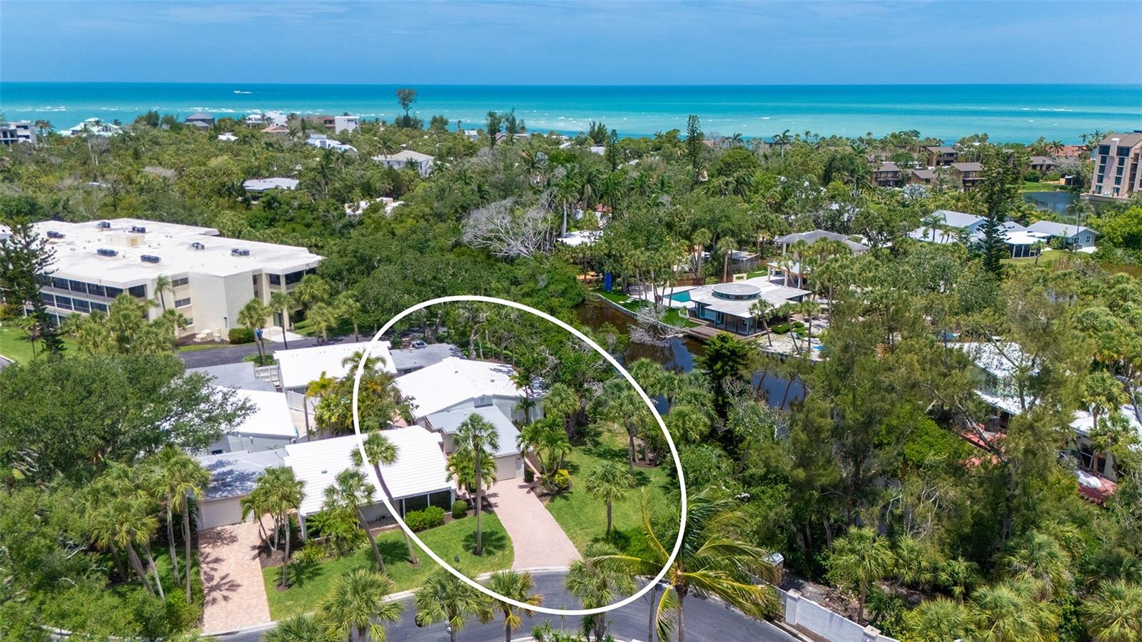 Tucked away in a peaceful, private setting overlooking the tranquil, shimmering lagoon - with its abundant fish, birds, and aquatic life - this beautifully updated 3 Bed/2 Bath villa in the premier GULF FRONT property of Whispering Sands offers the perfect blend of comfort, style and serenity. Step inside to discover a bright NEW kitchen featuring new granite countertops, stainless appliances, recessed & under cabinet lighting and an open, inviting feel ideal for everyday living and entertaining alike. Engineered wood flooring flows throughout the home, complemented by neutral paint tones, new interior doors, and thoughtfully updated baths with granite counters, new vanities and modern fixtures. A spacious screened brick paver lanai extending the full length of the residence may well be the star of the show, creating an ideal private indoor-outdoor living space to relax and enjoy the lush tropical surroundings. A private fenced brick paver patio offers an additional retreat for entertaining, dining al fresco, or simply unwinding in the Florida sunshine. Additional upgrades include a newly painted 1-car garage with new full-sized washer and dryer and new sink. The freshly painted front door, new screen door - along with a brick paver sidewalk and driveway - enhance the home’s welcoming curb appeal. Newly painted exterior in 2025. New landscaping is planned for the complex in 2026.  Whispering Sands is a 55+ Gulf front property offering 800’ of PRIVATE beach, 2 heated pools, beachside Tiki Hut and grills, shuffleboard, & canoe/kayak storage. The clubhouse is currently undergoing complete remodeling and will include fitness rooms, a full catering kitchen, large screen TV, and an elegant, comfortable space for social events. Ideally located just around the corner from the shops and restaurants of Siesta Key Village, this move-in ready property combines stylish updates, abundant outdoor living space, and a truly peaceful location to create the perfect coastal retreat!