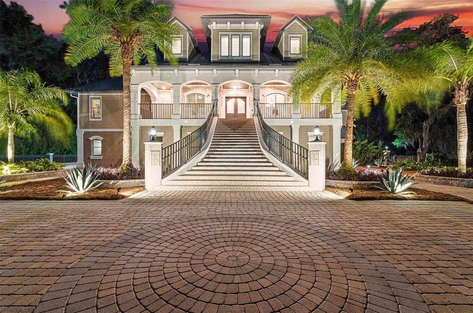 Set along the banks of the storied Saint Johns River, this home offers front-row views of Floridas living landscape. 140 Monterey Bay Lane is an extensively restored Riverfront Estate that is an exquisite blend of elegance and privacy. This custom-built home rests in a quiet sophistication between two rapidly expanding towns, and is just ten minutes from the newly opened First Coast Expressway, providing future access to the historic charm of St. Augustine and the coastal beauty of Florida's beaches. An impressive three-story, 6-bedroom, 6-bath home with elevator access to all levels - spans 6,780 square feet and offers abundant storage throughout. Designed for entertaining, the resort-style amenities include a sprawling heated pool with a bridge and dual waterfalls, a brand-new summer kitchen, and a covered outdoor patio, all nestled on more than 3.8 beautifully landscaped acres. Complete with first floor apartment suite, a 2000+ sq ft RV and Boat Garage, and over 2000 sq ft of river dockage.

Soaring 28-foot tongue-and-groove ceilings and shiplap walls highlight the entire home, while 16-foot wide fully retracting sliding glass doors plus a wall of windows above offer panoramic river views and seamless indoor-outdoor flow. Custom millwork, walnut hardwood flooring, integrated surround sound, floor electrical ports, and a floor-to-ceiling stone fireplace combine beauty and function. The chef's kitchen is designed for effortless entertaining with built-in Thermador and Miele appliances. An oversized-level 5 granite island anchors the space, surrounded by beautiful and functional custom cabinetry. A U-Line wine fridge at the built-in bar with wine rack and additional storage, along with a spacious walk-in pantry with counter plugs and adjustable shelving complete the ensemble. The luxurious owner's suite is a spa-like sanctuary, complete with a steam shower, Kohler 12 head full body shower system, overflow Kohler 12 jet hydrotherapy tub for two, Majestic LP gas fireplace, and a custom walk-in closet. Whole house is powered by an updated Crestron smart home system via mobile app and handheld remotes with custom room-by-room audio. Additional features include flawless Starlink internet, and three American Signature HVAC systems. Isonene insulation, a whole-home surge protector, and a 21kW Briggs & Stratton auto-on generator ensure efficiency and peace of mind.
