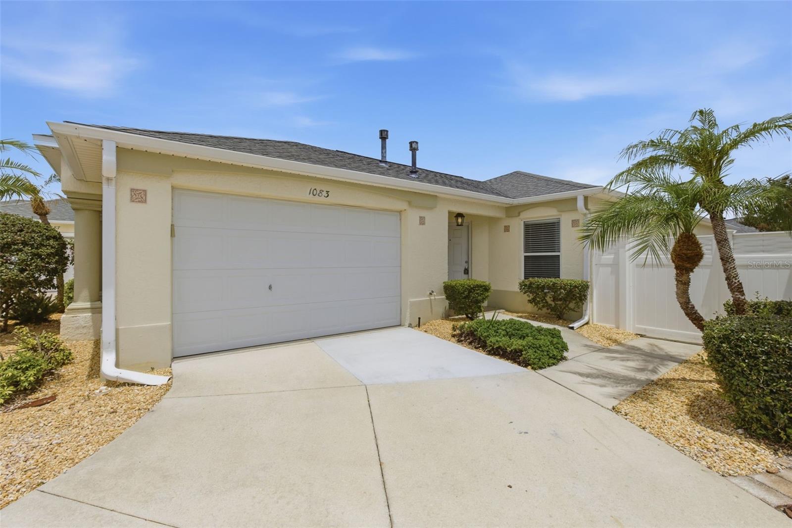 One or more photo(s) has been virtually staged. This is a must-see Courtyard Villa.  Located in The Villages just south of Lake Sumter Landing in the highly sought-after Village of VIRGINIA TRACE! This beautifully updated 2-bedroom, 2-bath Beauregard model villa now combines a prime location with modern, move-in-ready upgrades. Step inside to an inviting open-concept kitchen, newly redesigned with waterfall-edge quartz countertops, brand-new stainless-steel appliances, and a clean, contemporary layout perfect for entertaining. The home features matching luxury vinyl plank flooring throughout, including the enclosed patio, creating a seamless and stylish flow from room to room. Both bedrooms provide private en-suite bathrooms, and the primary bath has been completely renovated with a gorgeous walk-in shower and updated finishes. The enclosed patio provides additional flexible living space with great natural light, while the fully fenced courtyard and private backyard provides a peaceful outdoor retreat with attractive landscaping. Constructed with durable block and stucco, this villa is located closest to Lake Sumter Landing, giving you unbeatable access to dining, shopping, and nightly entertainment. You’re also just moments from the Canal Street Recreation Center with swimming, pickleball, shuffleboard, tennis, and fitness classes. With a low bond balance, modern upgrades, and a premier location, this home delivers exceptional value, lifestyle, and convenience. Roof Replaced in 2020, HVAC replaced 2026, Hot Water Heater 2026.