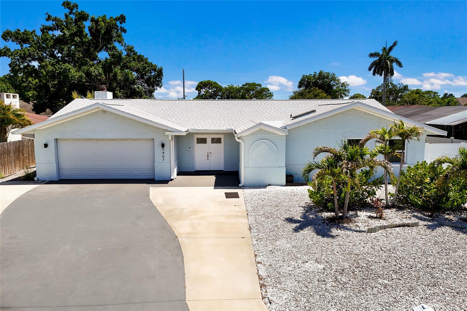 Welcome to your own private Florida retreat in the highly sought-after Harbor Woods community of Northwest Bradenton. Perfectly positioned just minutes from the pristine Gulf beaches of Anna Maria Island, this beautifully renovated turnkey furnished 4-bedroom, 2-bath pool home offers the ideal blend of comfort, style, space, and resort-inspired outdoor living. Extensively updated and thoughtfully improved, this move-in-ready residence showcases numerous renovations completed in 2022, along with major system upgrades that provide peace of mind for years to come. Currently utilized as a successful rental property, this home offers an excellent investment opportunity. From the moment you arrive, you’ll appreciate the inviting curb appeal and spacious layout designed for both everyday living and entertaining. Step inside to discover soaring vaulted ceilings, abundant natural light, and an open-concept floor plan that creates a bright and airy atmosphere throughout the main living areas. The expansive great room serves as the heart of the home, featuring dramatic architectural windows that frame tropical landscaping while filling the space with natural light and creating seamless indoor-outdoor connections. The updated kitchen is designed to impress, featuring quartz countertops, stainless steel appliances, ample cabinetry, generous prep space, and a stylish pass-through bar area perfect for serving guests and gathering with family. Adjacent dining and living spaces offer flexibility for both formal entertaining and casual everyday living. The spacious primary suite serves as a private retreat with room for a king-sized bed and sitting area, while the beautifully renovated ensuite bathroom features dual vanities, modern fixtures, abundant storage, and an oversized walk-in shower with elegant finishes. Three additional bedrooms provide comfortable accommodations for family and guests, including a large guest room ideal for multiple sleeping arrangements. The updated guest bathroom showcases contemporary finishes and designer touches that complement the home’s overall aesthetic. The true highlight of this property is the exceptional outdoor living experience. The sparkling heated pool and spacious sun deck creates a private backyard oasis that can be enjoyed year-round. Multiple lounging areas provide endless opportunities for relaxation, while the oversized pool deck offers plenty of space for entertaining family and friends. The beautifully maintained grounds feature tropical landscaping, low-maintenance artificial turf, private vinyl fencing, and multiple outdoor gathering spaces. Every detail has been thoughtfully designed to maximize enjoyment of the Florida lifestyle. Located in one of Northwest Bradenton’s most desirable neighborhoods, Harbor Woods offers convenient access to Anna Maria Island, Palma Sola Bay, Robinson Preserve, De Soto National Memorial, boating, fishing, waterfront dining, shopping, parks, medical facilities, and highly rated schools. Enjoy easy access to some of Florida’s most beautiful beaches while remaining close to all the conveniences of everyday living. Whether you’re searching for a primary residence, seasonal retreat, vacation home, or investment opportunity, this property offers an exceptional combination of location and Florida charm. Rarely does a home combine extensive renovations, major system updates, resort-style amenities, and an unbeatable Northwest Bradenton location quite like this one!