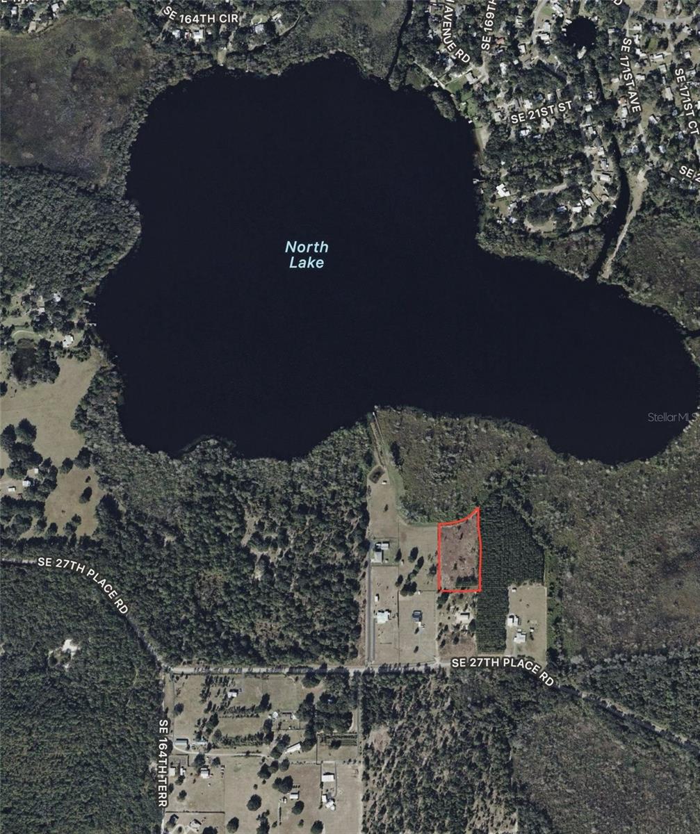 Build your legacy on this expansive 3 plus acre waterfront parcel in Ocklawaha, Florida, with Owner Financing available, situated on the pristine, spring-fed shores of North Lake in Marion County near the Ocala National Forest. This oversized lot represents a "vanishing breed" of Florida acreage, featuring a mature hardwood canopy, natural elevation, and "dark sky" views perfect for a custom luxury estate within the limited-access enclave. Residents enjoy the security of a private community boat ramp and a location far removed from urban density, yet within an hour of Orlando and Daytona. Whether you envision a sprawling Mediterranean manor or a modern glass sanctuary, this A-1 zoned land provides the architectural scale required for absolute solitude with a deep, reflective waterfront backdrop. Key features include private lakefront access, rolling topography, and a nearby utility pole (well/septic required). Secure your piece of the Florida lake region today. A true sanctuary for those who value silence, consistent water levels, and the natural world.