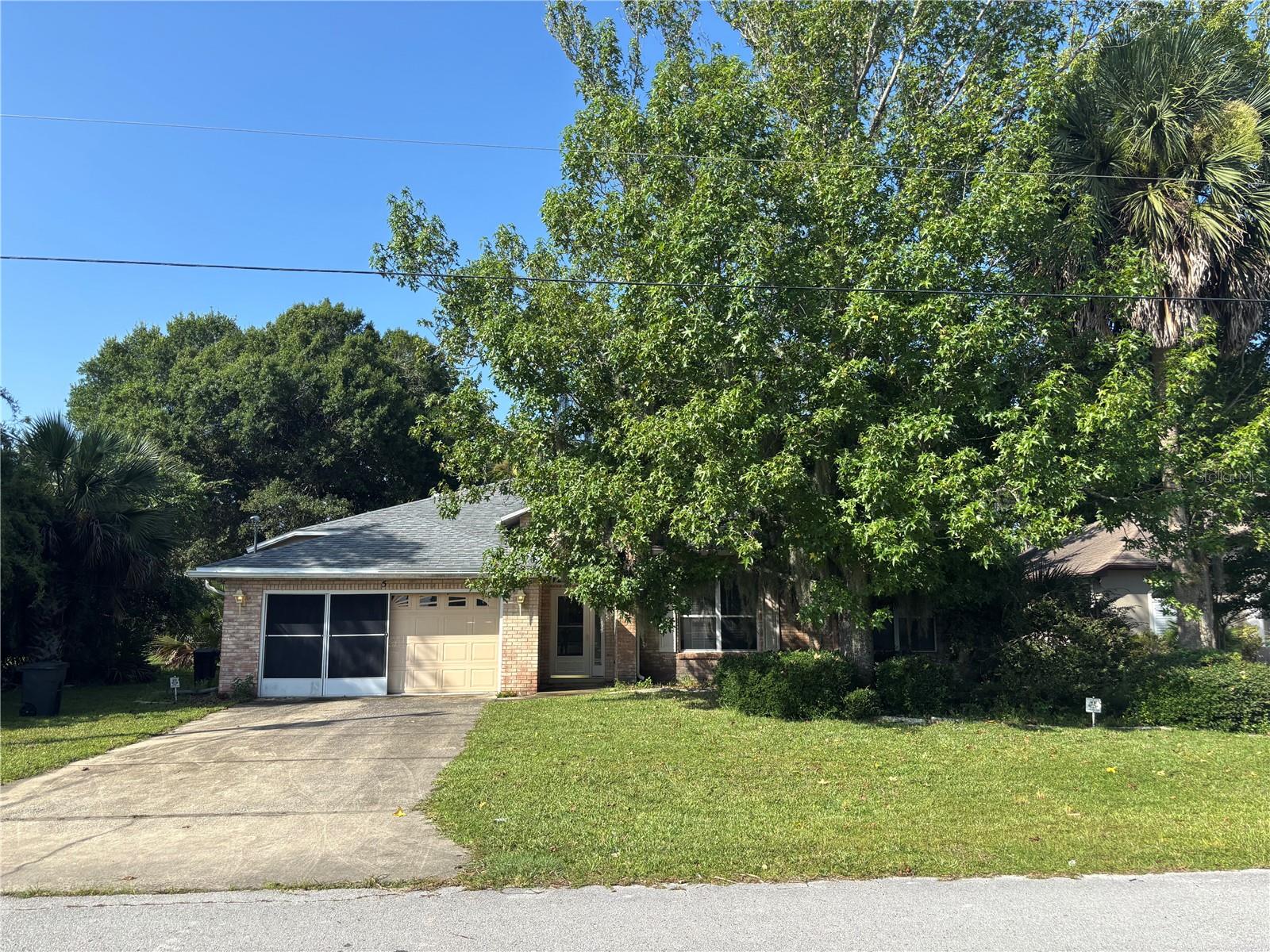 Welcome to this move-in ready 3-bedroom, 2-bath home offering 1,696 square feet of comfortable living in the desirable Indian Trails neighborhood of Palm Coast. Whether you're searching for a primary residence, starter home, second home, or investment property, this home - built of concrete block, stucco, and brick -  checks all the boxes. With no HOA or CDD, the only thing this home needs is a little TLC. 
The updated kitchen features newer cabinets with pull out shelving for easy pantry access as well as under and over cabinet lighting.  Together with the stainless steel appliances and granite countertops, the kitchen is a stylish and functional space for everyday living. Major updates to the property provide peace of mind, including a new roof (2020) and A/C system (2019). Ceiling fans throughout the house are an added bonus, as are the higher ceilings. A large walk-in closet in the master bedroom as well as a storage closet in the laundry room provide additional storage.  The garage has a utility tub for those outside chores. Enjoy Florida living with a screened lanai overlooking the spacious, partially fenced backyard. With plenty of room to add a pool, the outdoor space offers endless potential for entertaining, gardening, or simply relaxing. Gutters add to the home's practicality and curb appeal.Conveniently located with easy access to shopping, restaurants, and I-95, this home is also just a short drive to beautiful Jungle Hut Beach. Families will appreciate its proximity to A-rated schools. Palm Coast's ideal location between historic St. Augustine and vibrant Daytona Beach provides easy access to the best of Northeast Florida's beaches as well to Central Florida's dining and attractions.Don't miss this exceptional opportunity to own a well-maintained home in one of Palm Coast's most sought-after neighborhoods!
