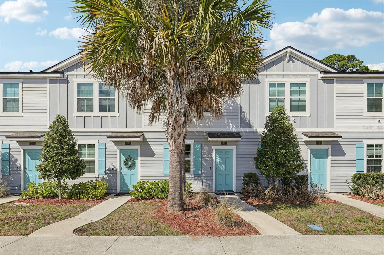 Fully furnished turnkey ready townhome! Former model is in the best location here. Only 2 miles to historic downtown St. Augustine. Beautiful views of the preserves live oak trees with Spanish moss and palms. Sold fully and luxuriously furnished, 2 bedroom 2.5 bath townhome has 1,109 sq ft of well-organized space that has barely been lived in and shows like new! 30 Day Mid-term Rentals allowed! Beautifully maintained low maintenance in Whispering Creek community stands out as a true move-in ready opportunity with a vibrant artistic flair. Designed with a modern Miami-inspired style, the home features colorful décor and thoughtful finishes that make it feel like stepping into a designer model home. The  inviting two-story layout offers a welcoming kitchen that opens directly into the living room creating a connected space that works beautifully for both everyday routines and entertaining. The kitchen includes a generous bar that provides extra counter space for meal prep, casual dining, or hosting guests while you cook. Sliding glass doors fill the living area with natural light, brightening the home and enhancing the sense of openness throughout the day.  Custom shiplap siding both in living and kitchen bar adds a casual and soothing design touch.  Upstairs, the primary bedroom offers a relaxing escape with a spacious walk-in closet and a well-appointed bathroom with a large vanity. Upstairs, you'll find two spacious bedrooms, each with walk-in closets and ceiling fans, offering comfort and functionality. All bedrooms are located on the second level, creating a private retreat separate from the main living areas. Step outside to a peaceful and private backyard that faces a private wooded area, perfect for relaxing or enjoying the natural surroundings. The yard includes a half wooden privacy fence, and the community allows fully fenced yards. Investors will also appreciate that monthly rentals are permitted. Residents of Whispering Creek enjoy a low-maintenance lifestyle with lawn care and landscaping included, along with assigned parking and guest spaces. The community also features sidewalks, scenic ponds, and a central mailbox area, creating a welcoming neighborhood environment. Front of community offers a retail center with restaurants and shops! Extremely good location next to St Augustine High School, 2 miles to historic downtown and 4 miles to famed Vilano Beach. Jacksonville Int’l Airport is only 45 miles away. You'll have easy access to dining, shopping, and coastal living. Whether you're searching for a primary residence, vacation getaway, or investment property, this stylish, turnkey townhome is ready to enjoy from day one. Equipped with smart home technology, allowing remote control of features such as entry access, air conditioning, and the alarm system (ATT service activation required). Pets allowed with restrictions.  There is nothing quite like this furnished property in the entire area at this price.  Come see it...