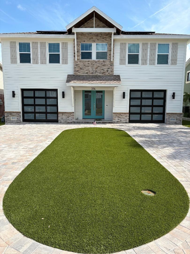 Located in beautiful Indian Rocks Beach, must see this 2024 custom home. This 2 bedroom, 2 bath, plus office area, is a must see. All concrete construction, Hurricane windows and doors, elevated living. With 9'+ ceilings, 8' interior doors adding to wide open concept and feel. You will love the custom chef's kitchen with built ins. Enjoy water views from your kitchen, dining area, and living room. Enjoy spacious living room with fire place. Primary bedroom / bathroom has custom built in closet, double vanities, and custom  "curb-less" shower.  For you auto enthusiast, the garage has space for 4 cars, 41' x 43', tall enough to handle auto stacker / lift, for more car storage. Includes plenty of work area as well. Also has mini split A/C on one side The pool is very unique / custom, located on second floor with your outside patio / cooking area. Balcony includes electric / remote, retractable awning over cooking / sitting area. The pool is salt water with gas pool heater, so that you can enjoy all year round. This home has natural gas tankless water heater, whole house generator, Stainless Steel gas appliances, note dryer is on natural gas, plus home owner owned solar panels, (32) making electric bill seem non existence. Has new seawall, so add you dock / lift to fit your boating needs. Has out side lower level shower so you can rinse off after a day of boating / fishing. As for the exterior, this home is perfect for your main residence, second home, or short term rental, requires very little maintenance, custom artificial turf, front and back yard, paver driveway.