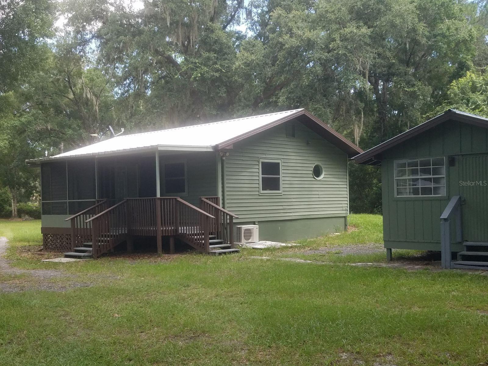 Lovely country setting with newly remodeled 1/1 cottage on 5.7 acres.  This charming cottage is  fully updated.  Four outbuildings on the property, along with a large size above ground pool and deck.   5 RV hookups and 4 cement pads for parking.  Ample water spigots around the property. 2 septic systems, one for the house and one by the RV pads.  Metal roof on cottage was new in 2020.  Metal roofs on laundry room, pool house and workshop less than 1 year old. Home has energy efficient windows, 2 mini splits that heat and cool quietly and efficiently.  On demand hot water heater.    10X12 shed behind laundry room does not convey.  More pictures will be posted soon.  Seller is licensed Real Estate Agent.