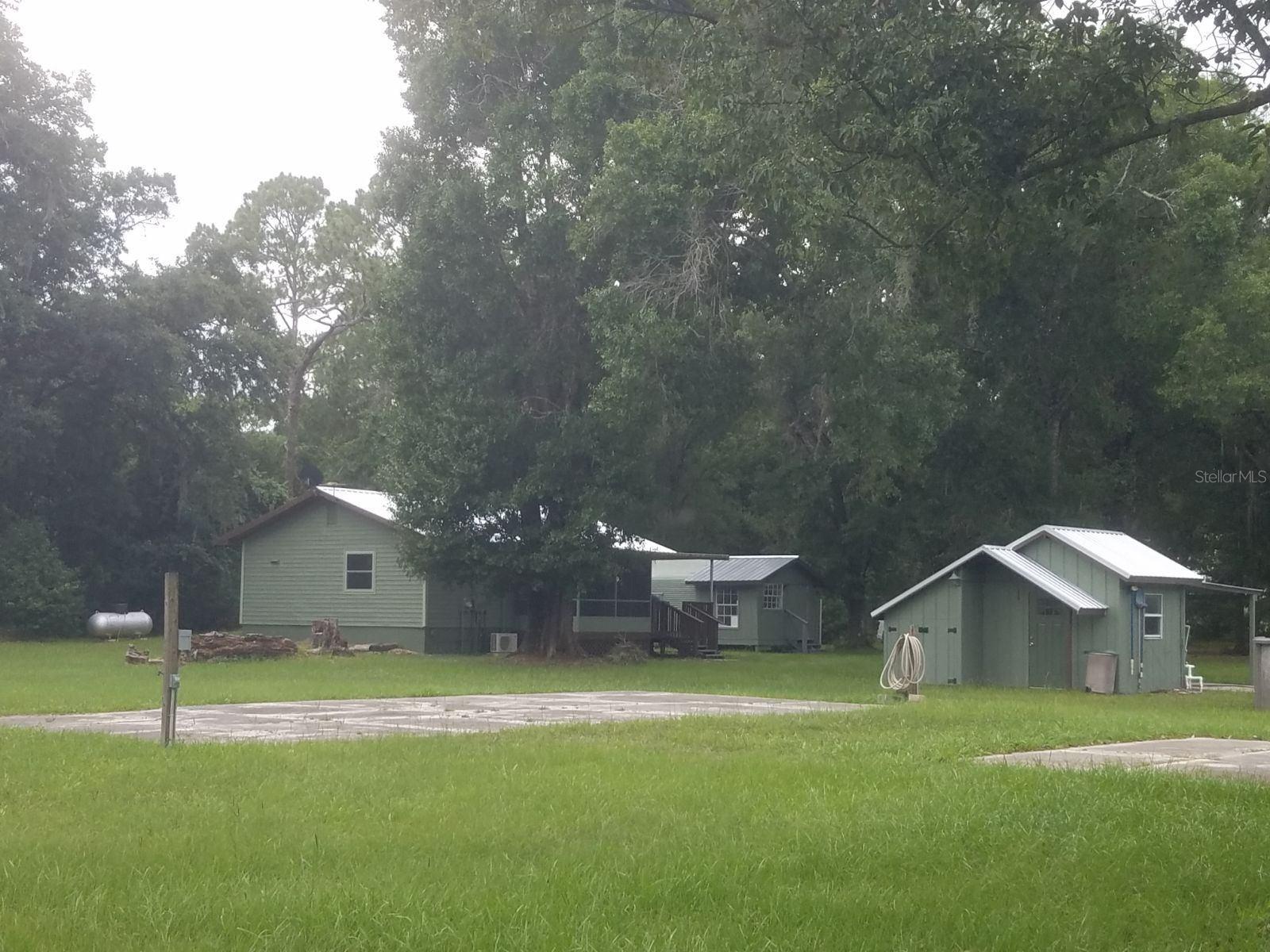 Lovely country setting with newly remodeled 1/1 cottage on 5.7 acres.  This charming cottage is  fully updated.  Four outbuildings on the property, along with a large size above ground pool and deck.   5 RV hookups and 4 cement pads for parking.  Ample water spigots around the property. 2 septic systems, one for the house and one by the RV pads.  Metal roof was new in 2020.  Home has energy efficient windows, 2 mini splits that heat and cool quietly and efficiently.  On demand hot water heater.   10X12 shed behind laundry room does not convey.  More pictures will be posted soon.  Seller is licensed Real Estate Agent.