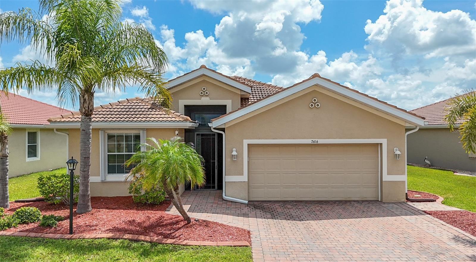 Virtually Staged. Please see the 3D interactive tour! Welcome to this beautifully maintained 3-bedroom, 2-bath home with a versatile den, ideally situated in the highly sought-after gated community of Talon Bay. Built in 2014 and offering over 1,900 square feet of thoughtfully designed living space, this home features an open-concept floor plan filled with abundant natural light and ceramic tile flooring throughout—no carpet anywhere. The spacious kitchen is equipped with granite countertops, rich wood cabinetry, a pantry, a center island, and overlooks the expansive great room and adjacent dining area, making it perfect for both everyday living and entertaining. The split-bedroom layout provides privacy, with generously sized guest bedrooms offering plenty of space for larger furniture while remaining separate from the primary suite. The den, complete with French doors, makes an ideal home office, flex space, or additional guest room. A convenient inside laundry room, 2-car garage, water softener, and accordion hurricane shutters provide added comfort and peace of mind. The spacious primary suite is a relaxing retreat with peaceful lake views, two walk-in closets, and a luxurious en-suite bathroom featuring dual vanities, a tiled walk-in shower with glass enclosure, and a soaking tub. Step outside to the extended screened lanai, where a motorized sunshade provides comfort while you enjoy the beautiful lake views. With plenty of room for outdoor seating and dining, this space is perfect for relaxing or entertaining family and friends. Talon Bay is a friendly, gated community offering an outstanding selection of amenities, including a heated resort-style pool, clubhouse with a screened sitting area and grilling space, fitness center, tennis courts, and more. Combining an exceptional home, scenic lake views, and fantastic community amenities, this property offers the perfect Florida lifestyle.