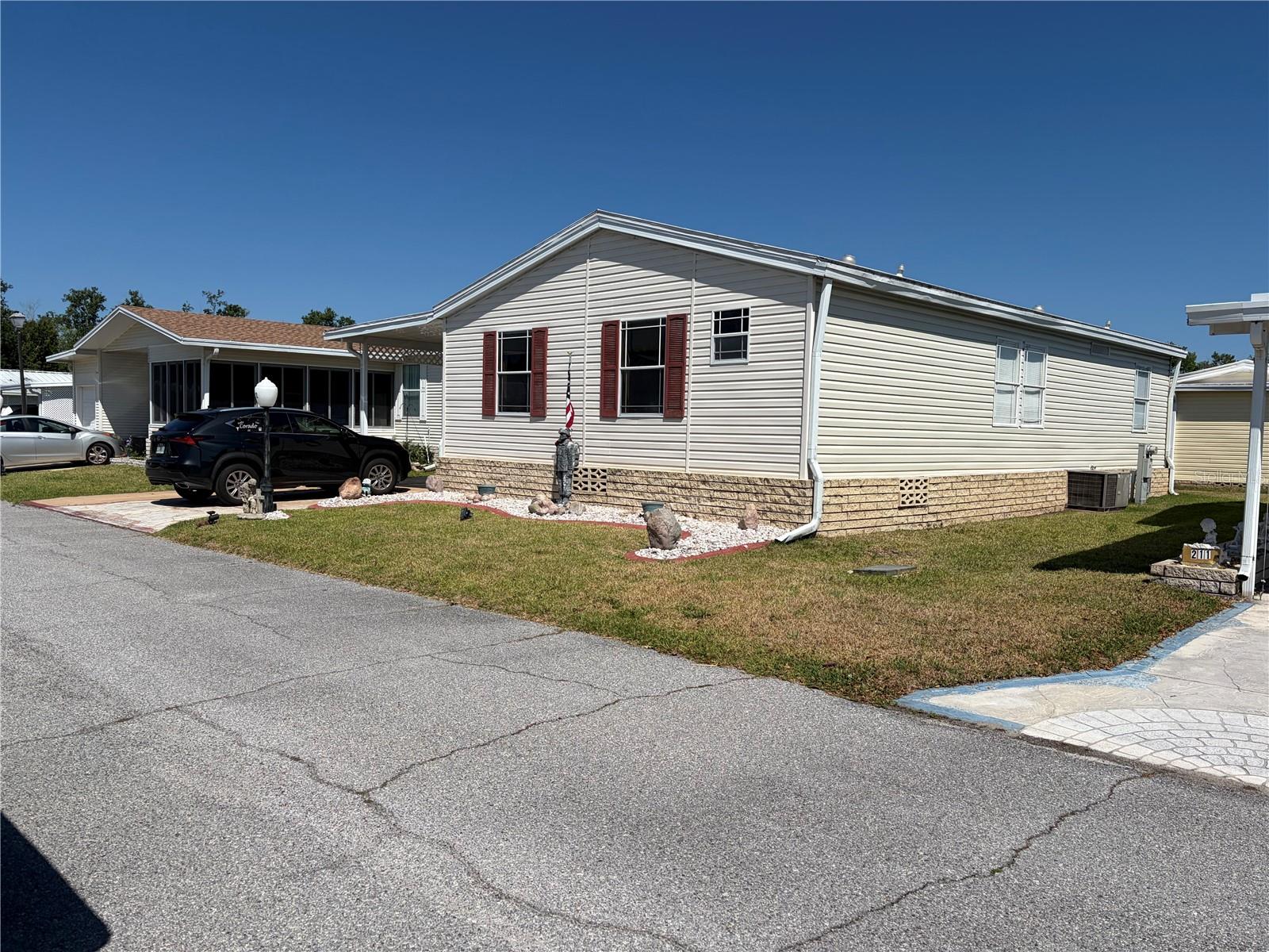 This 2005 split bedroom home has 1170 SF of living space. A/C unit has been serviced annually and is in good condition. The Rubber roof over is in good condition and has a lifetime warranty.  Windows are single pane, no gray pipe. Large Florida room with vinyl windows.  Appliances are original except for the refrigerator & stove which are newer. As you enter the front room there is a very nice coat closet for storage. Laundry is located in the kitchen.  The house will be partially furnished.  The golf cart will stay with the house, as well. Sweetwater is a very active 55+ community. We have a heated & chilled pool, hot tub, exercise room. The clubhouse contains an ole Fashion English Pub, along with 2 Billiard table, shuffleboard table, and a beautiful Ball room for parties and meetings.