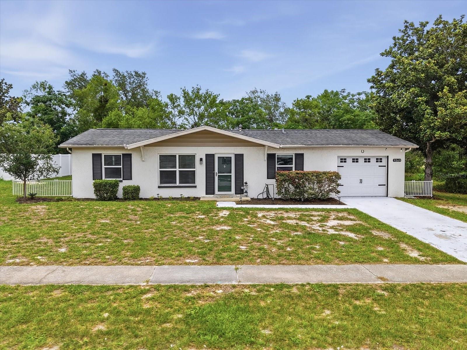 2/2 single-family home with bonus office space, bonus Florida room, covered screened porch, and one car garage in Spring Hill. No HOA, no CDD, flood zone X. Newer AC, windows, electrical panel, roof (2013), updated bathrooms, custom closets, gas range, and gas grill! **Preferred Lender is offering 1 year of 1 percent lower interest rate paid by lender!** Welcome to 9269 Marler Road, where thoughtful updates, flexible living space, and Florida outdoor living come together in a home that offers both charm and peace of mind.

Located in an X flood zone with no required flood insurance, no HOA, and no CDD fees, this beautifully maintained property provides the freedom and affordability that many buyers are looking for.

Inside, you'll find water-resistant laminate flooring, crown molding, 5.25-inch baseboards, updated lighting and ceiling fans, built-in shelving, and custom storage throughout. The functional floor plan is enhanced by a dedicated office space off the garage, offering the flexibility needed for remote work, hobbies, fitness equipment, or a quiet retreat.

The updated kitchen features double-stacked painted cabinetry, subway tile backsplash, open shelving, stainless steel appliances, and a gas range. A charming coffee bar can remain with the home, creating the perfect spot to start your day.

The primary suite includes a stylish barn door and built-in closet storage, while both bathrooms have been tastefully updated with newer vanities, toilets, glass shower doors, and upgraded shower systems with body sprayers for a spa-like feel.

Double doors with built-in blinds lead to the covered lanai and screened outdoor living area with electrical, creating a seamless transition between indoor and outdoor spaces. The spacious backyard offers privacy, room to entertain, and plenty of space for pets, gardening, or play. The outdoor grill is directly connected to gas and will stay with the property.

Additional features include built-in closets throughout, a linen closet, inside utility room with cabinetry, washer and dryer included, blinds throughout, a one-car garage with opener and pebble-finish flooring, and newer windows that enhance energy efficiency and natural light.

Major updates provide confidence for years to come, including a newer AC system (approximately two years old), new electrical panel, roof replaced in 2013, gas water heater, and gas stove supplied by an AmeriGas tank.

Conveniently located near shopping, dining, parks, Weeki Wachee Springs, and the Gulf Coast's outdoor recreation opportunities, this move-in-ready home combines modern updates, flexible living, and everyday comfort without the added expense of HOA, CDD, or required flood insurance.
