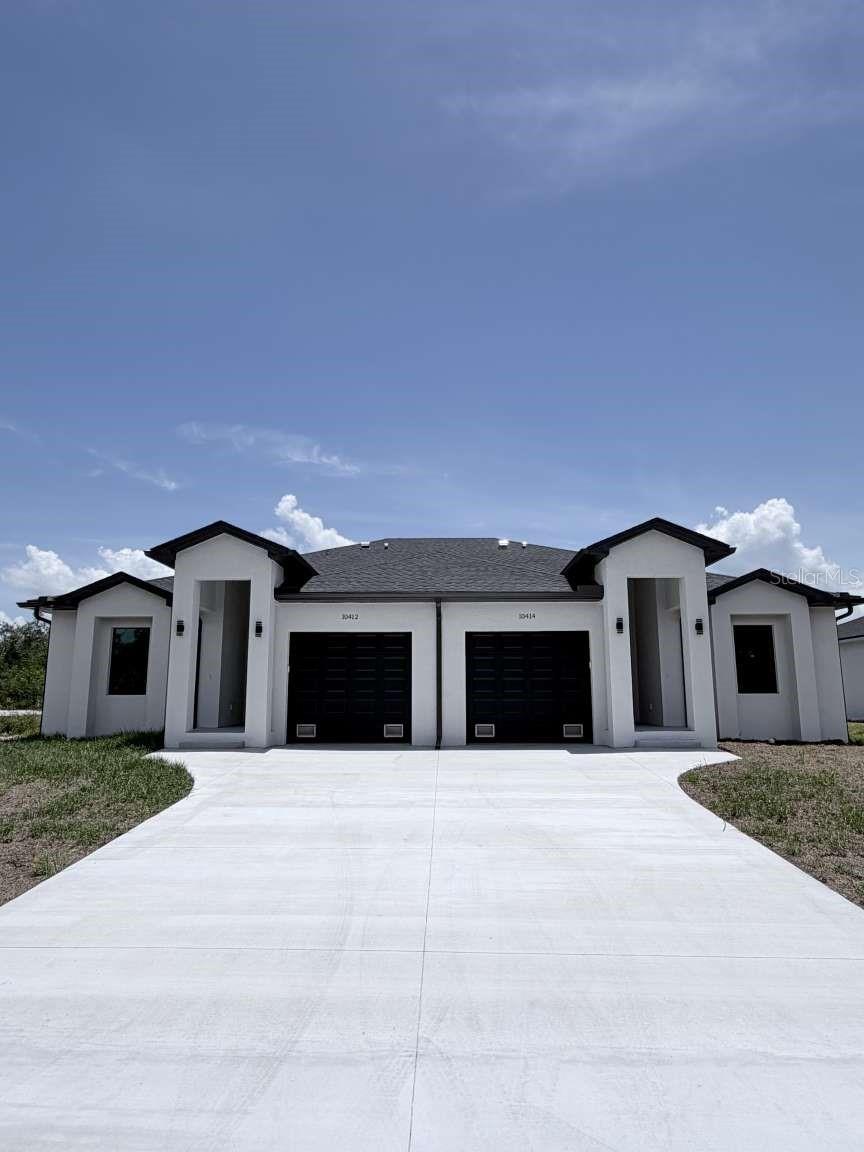 Introducing a brand new, income-producing duplex in the highly desirable community of South Gulf Cove, an exceptional investment opportunity with strong rental potential and long-term value. Built in 2026, each unit offers 1,198 sq. ft. under air featuring 3 bedrooms, 2 bathrooms, a spacious one-car garage, and hurricane impact windows and doors. Designed with modern living in mind, both units feature an open-concept floor plan with a seamless kitchen and living room combination, breakfast bar seating, and durable finishes throughout, creating a functional and inviting space ideal for families, seasonal residents, or long-term tenants. Whether you are looking to expand your investment portfolio, live on one side while renting the other, or accommodate multi-generational living, this turn-key duplex offers flexibility and immediate income-producing potential. Conveniently located in one of Port Charlotte's fastest-growing waterfront communities, residents are just minutes from Gulf Coast beaches including Boca Grande and Manasota Key. Enjoy easy access to shopping, dining, hospitals, schools, public boat ramps, golf courses, and outdoor recreation. Boating enthusiasts will appreciate the nearby waterways and marinas, while golfers are only a short drive from local favorites such as Rotonda Golf & Country Club. With continued growth throughout the area, this property is positioned for both appreciation and steady rental demand. Do not miss the opportunity to own a newly built duplex in one of Southwest Florida's sought-after and rapidly expanding communities - a smart investment with immediate cash-flow potential and lasting value.