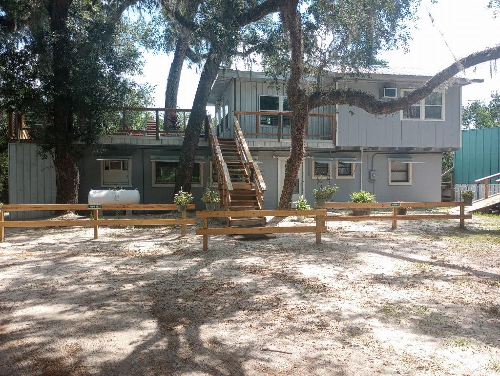 Escape to the "Real Florida" with this rare riverfront opportunity in between the historic charm and conveniences of White Springs, Live Oak and Lake City. Tucked away at the end of a scenic canopy road, this 2-bedroom, 2-bathroom home offers the perfect blend of secluded tranquility and modern convenience. Whether you are looking for a peaceful primary residence, a seasonal getaway, or a high-potential investment property, this Suwannee River gem delivers.

Investment Potential: Airbnb & Rental Flexibility - This property features a versatile layout that can easily be divided into two separate 1-bedroom, 1-bathroom units. This unique configuration allows for maximum rental flexibility—live in one side while renting the other or manage two independent short-term rentals.

Situated on a lush 0.63-acre lot, the property is shaded by magnificent ancient oaks draped in Spanish moss. The home is designed to celebrate its environment, featuring a spacious rooftop deck—the ultimate spot to unwind while overlooking the tea-colored waters of the Suwannee or stargazing in the quiet of the North Florida nights. You can even launch your canoe right from the property with the installed powered winch.

Enjoy being minutes away from fishing, kayaking, and the scenic trails of Stephen Foster State Park (across the river) and Big Shoals. You get the peace of the woods with the convenience of being near local amenities and easy access to I-75.

Don't miss out on this turnkey riverfront investment—schedule your tour today!
