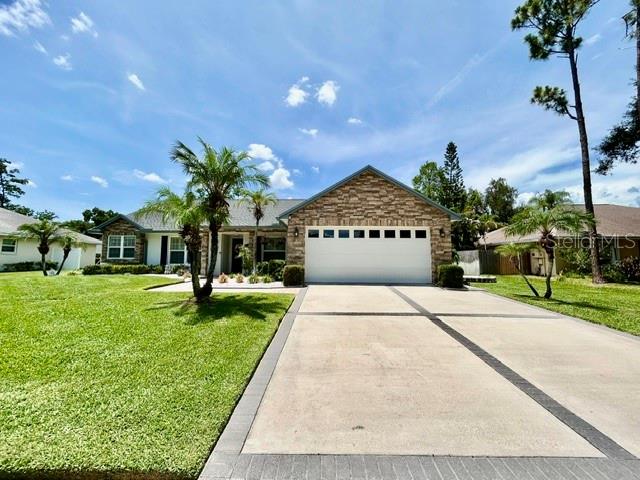 CUSTOM GORGEOUS HOME in Carrollwood shows true PRIDE OF OWNERSHIP...from the landscaping to every thoughtfully designed interior and exterior detail.  Custom Cobblestone accents, Brick Pavers, Reclaimed Water and an upgraded stunning wood Front Door create a warm and elegant entrance. Don't miss the DETAILS...Custom Cabinetry, Plantation Shutters, Bay Window, Wood framed doors throughout with Bull’s-Eye detailing, Wall Niches and Chair Rail Molding in the hallways, all add character throughout...A MUST SEE.  Enjoy a split floor plan. Your eyes will dance with delight as you walk into the 2nd and 3rd Bedrooms with WALK IN CLOSETS!!  The spacious Master Ensuite Bedroom is stately with plantation shutters overlooking your peaceful and private backyard.  The Ensuite Master Bathroom is complete with the same custom cabinetry and granite countertops as the kitchen...absolutely beautiful.  Don't miss the His and Hers Walk-In Closets and Stunning stone finished shower with built-in stone seat.  The Family Room features a Fireplace and CUSTOM Mantle and French Doors that open to a large screen lanai and beautifully landscaped large backyard.  Brace yourself for the stunning CUSTOM kitchen that features porcelain floors, elegant glass and wood cabinetry, granite countertops, a custom backsplash, upgraded lighting and Whirlpool Stainless Steel appliances… A Dream Kitchen. The Dining area is complimented by a Bay Window with Upgraded Plantation Shutters.  There is one WORD that describes this home...MAGNIFICENT!!