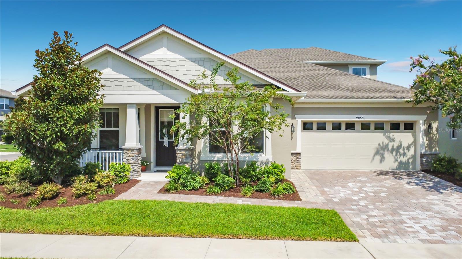 Welcome to 9068 Exploration Avenue, an impeccably maintained 4-bedroom, 3-bath residence ideally situated on a premium corner homesite with picturesque pond views in the highly sought-after Meridian Park at Lake Nona. Blending timeless design with modern finishes and an exceptional indoor-outdoor lifestyle, this thoughtfully designed home offers the perfect balance of comfort, style, and convenience.

A charming covered front porch welcomes you home and provides the perfect place to relax while enjoying tranquil pond views and breathtaking Florida sunsets. Inside, an abundance of natural light fills the open-concept living spaces, creating a bright and inviting atmosphere throughout.

Designed with both everyday living and entertaining in mind, the spacious kitchen serves as the heart of the home and features a large center island, beautiful quartz countertops, stainless steel appliances, ample cabinetry, and seamless flow into the expansive living area. A separate formal dining room offers the ideal setting for family gatherings, holiday meals, or elegant entertaining.

The spacious first-floor primary suite is a true retreat, complete with tray ceilings, dual walk-in closets, and a beautifully appointed en-suite bathroom featuring dual vanities, rimless glass walk-in shower and a relaxing garden soaking tub. Three additional generously sized bedrooms, two additional full bathrooms and an expansive upstairs loft provide exceptional flexibility for a media room, game room, home office, fitness space, or additional living area.

Additional highlights include wood-look tile flooring throughout the main living areas, an interior laundry room with washer and dryer included, a two-car garage, and a fully fenced backyard designed for entertaining with a covered lanai and an extended paver patio.

Residents of Meridian Park enjoy an outstanding collection of resort-style amenities, including a beautifully appointed clubhouse, resort-style swimming pool with splash pad, state-of-the-art fitness center, parks, playgrounds, dog parks, scenic walking trails, and community green spaces.

Ideally located in the heart of Lake Nona, this home is just minutes from Medical City, the USTA National Campus, Orlando International Airport, Brightline, premier golf, top-rated schools, and an outstanding selection of shopping, dining, and entertainment. With convenient access to SR-417 and SR-528, commuting throughout Central Florida is effortless.

Combining thoughtful design, premium finishes, a desirable corner homesite with picturesque pond views and an exceptional Lake Nona location, this beautiful Meridian Park home is the perfect place to call home.