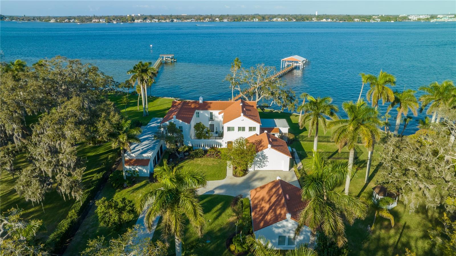 Auction Property. AUCTION BIDDING OPEN: Bidding ends December 14th. Previously Listed $4.95M. Current High Bid $3M. No Reserve. Saturday and Sunday 1-4pm, and Showings Daily By Appt. 

This gorgeous, Spanish-style estate sits on almost two acres with panoramic views of the Manatee River from nearly every room. Old-world charm meets modern luxury in this waterfront piece of paradise. The compound features a beautiful main house with abundant natural light and room for entertaining, from the comfortable living areas to the spacious kitchen with waterfall countertops and stainless steel appliances. The primary suite has a stunning bathroom with a freestanding tub and a sun-drenched dressing room. The estate also features a beautiful wood-paneled office, a studio space, and a first-floor bedroom with an ensuite bathroom and separate entrance. Take a dip in the heated indoor/outdoor pool or enjoy a tropical cocktail on the screened lanai overlooking the water. The brand-new dock and boat house features power lifts for Jet Ski’s and a 16,000-pound boat lift so you can enjoy watersports in your backyard. This tropical gem includes a .31 acre lot at 2832 Riverview Blvd, where you can build an additional house for relatives or guests.