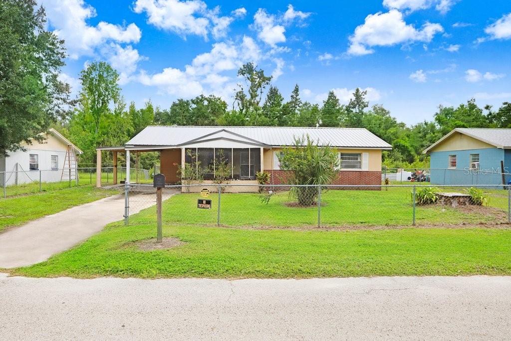 One or more photo(s) has been virtually staged. Come see this 3 bedroom, 1.5 bathroom, 2 carport, home that's perfect for a first time buyer or an investor! Located in a USDA-eligible area with NO HOA, a metal roof (July 2023), updated bathrooms (2024), new flooring (2024) and freshly painted interior (2024) - This could be the perfect starter home for you or your client. There's a screened front porch at your door and a basketball court / park about 300 yards away on the same street in the quaint town of Wauchula, FL. Enjoy Florida living from a fenced in yard, providing privacy and a perfect atmosphere for outdoor entertaining. The home is conveniently located near the historic, downtown main street area of Wauchula and about a 5 min drive to shopping and restaurants, including: Dunkin' Doughnuts, Advent Health Hospital, Beef O' Brady's Pub, & Wal-Mart. The pleasures of the great outdoors are also nearby and feature canoeing, kayaking and paddle boarding on the Peace River! Plus, it's about an hour's drive to Legoland (Winter Haven), Siesta Key Beach (Sarasota), and Lakeland Linder Airport (Lakeland). SCHEDULE YOUR SHOWING TODAY!! Sellers offering a 1 year home warranty!