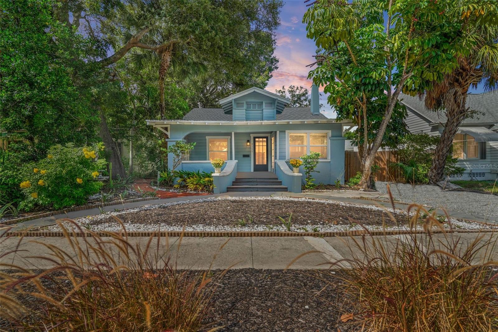 Nestled in the heart of the historic Kenwood neighborhood, this delightful coastal bungalow epitomizes move-in ready charm and modern comfort. A true gem of Kenwood's desirable Historic District, this 3-bedroom, 2-bathroom home offers a perfect blend of historic character and contemporary upgrades.

Step onto the welcoming covered porch, where the essence of this home's coastal charm begins. Inside, natural light dances through every corner, accentuating the spacious layout and highlighting the cozy fireplace—a centerpiece for creating cherished memories.

Thoughtful recent renovations over the past years includes a newer roof, a stylish kitchen adorned with solid wood, self-closing cabinets, and gleaming stainless-steel appliances, while newer flooring and windows enhance the home's allure, complemented by impeccably designed bathrooms and updated fixtures throughout.

Enjoy the serenity of the backyard oasis, complete with lush trees and a private entrance from the back alley. A versatile shed offers ample storage or workshop space and the potential for conversion into a garage.

Enhancing its appeal, this home resides on a brick-lined street, adding to its picturesque curb appeal within the vibrant Kenwood neighborhood. Central to the area's charm are the diverse dining and shopping options along Central Ave and downtown, with St. Pete Beach just a short drive away.

Discover the community spirit of Kenwood through its monthly porch parties and the cultural richness of the nearby Grand Central District. With its elevated location offering peace of mind from storm surges, Kenwood stands as one of St. Petersburg's most sought-after neighborhoods—a place where historic allure meets modern convenience.